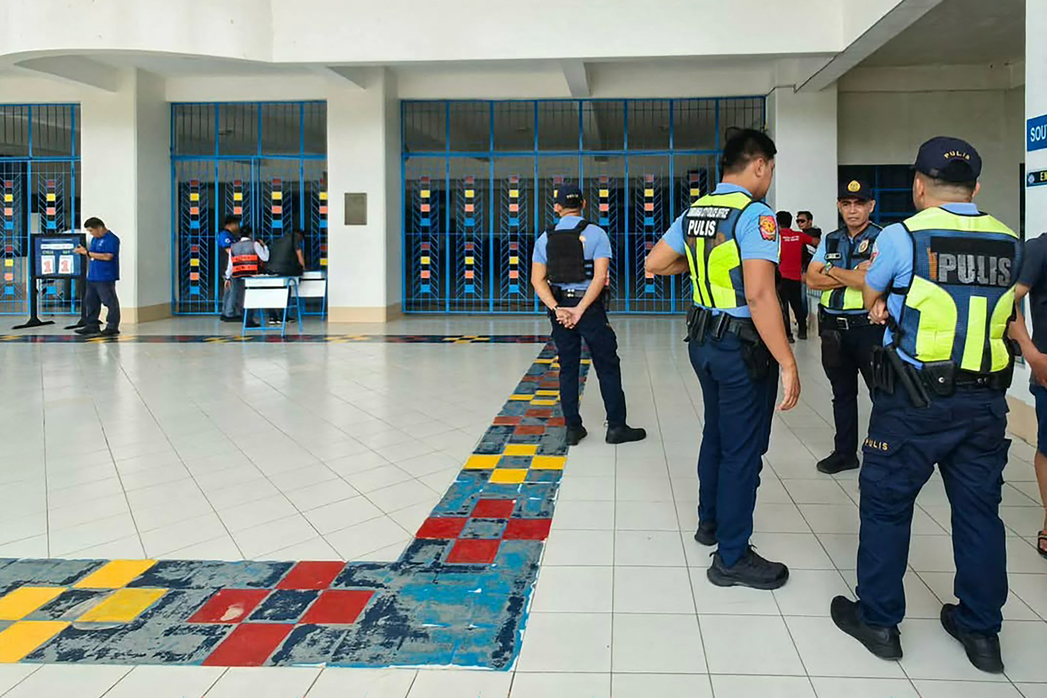 Philippine police gather at a school following a shooting in Zamboanga on 18 August 2026. A student was shot dead at a high school in the southern Philippines on August 18 before the alleged killer took his own life, police said (AFP/Getty)