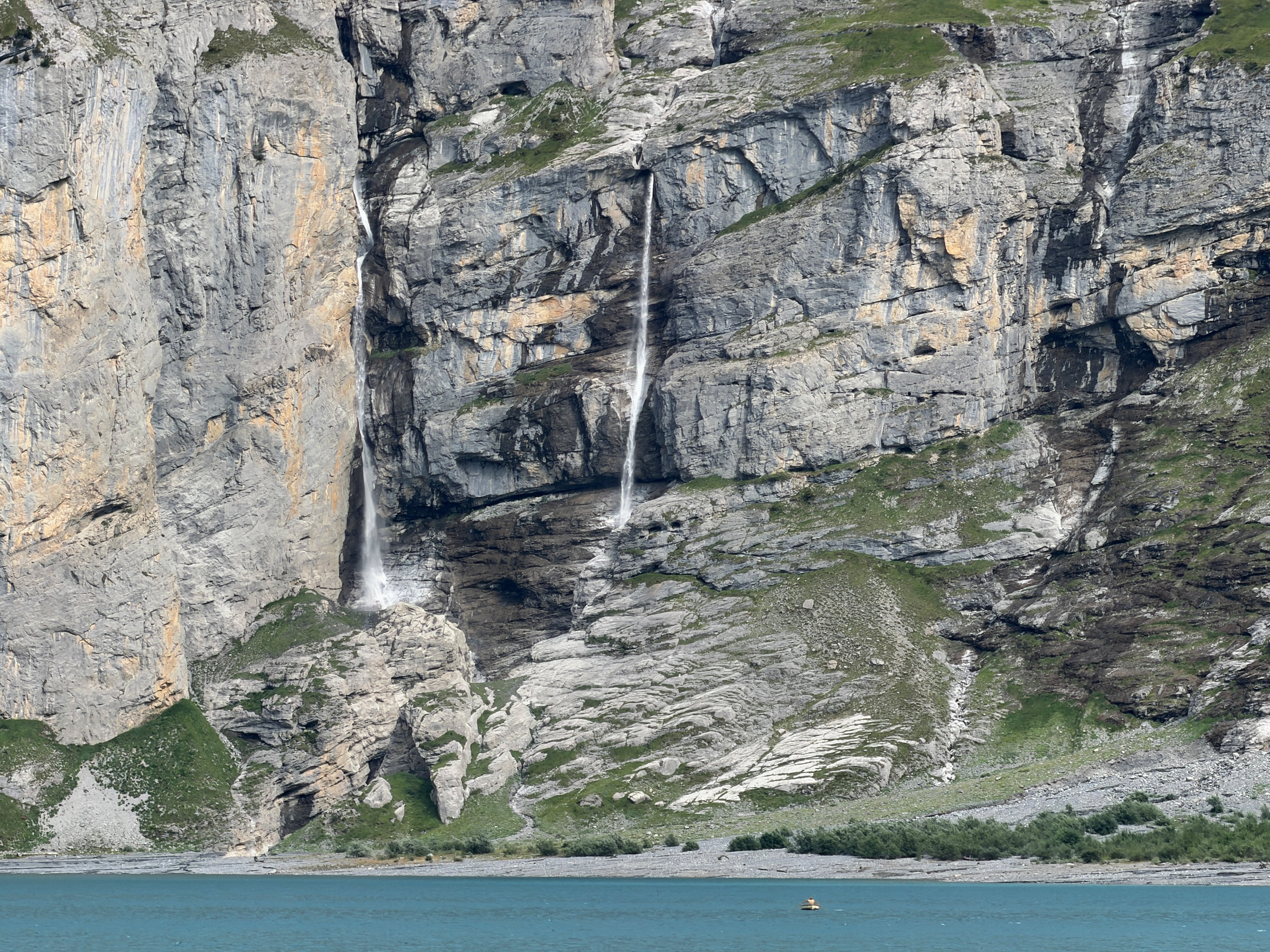 Streams of water from melting glaciers feeding Oeschinensee lake near Kandersteg, Switzerland, Tuesday, Aug. 4, 2026. (AP Photo/Hernan Munoz)