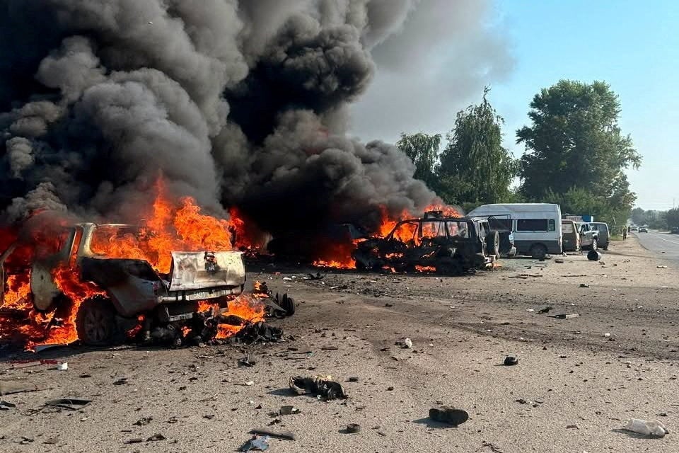 Vehicles burn after Russian drone strikes in the town of Pechenihy, during Russia's attack in Kharkiv on Tuesday (Reuters)