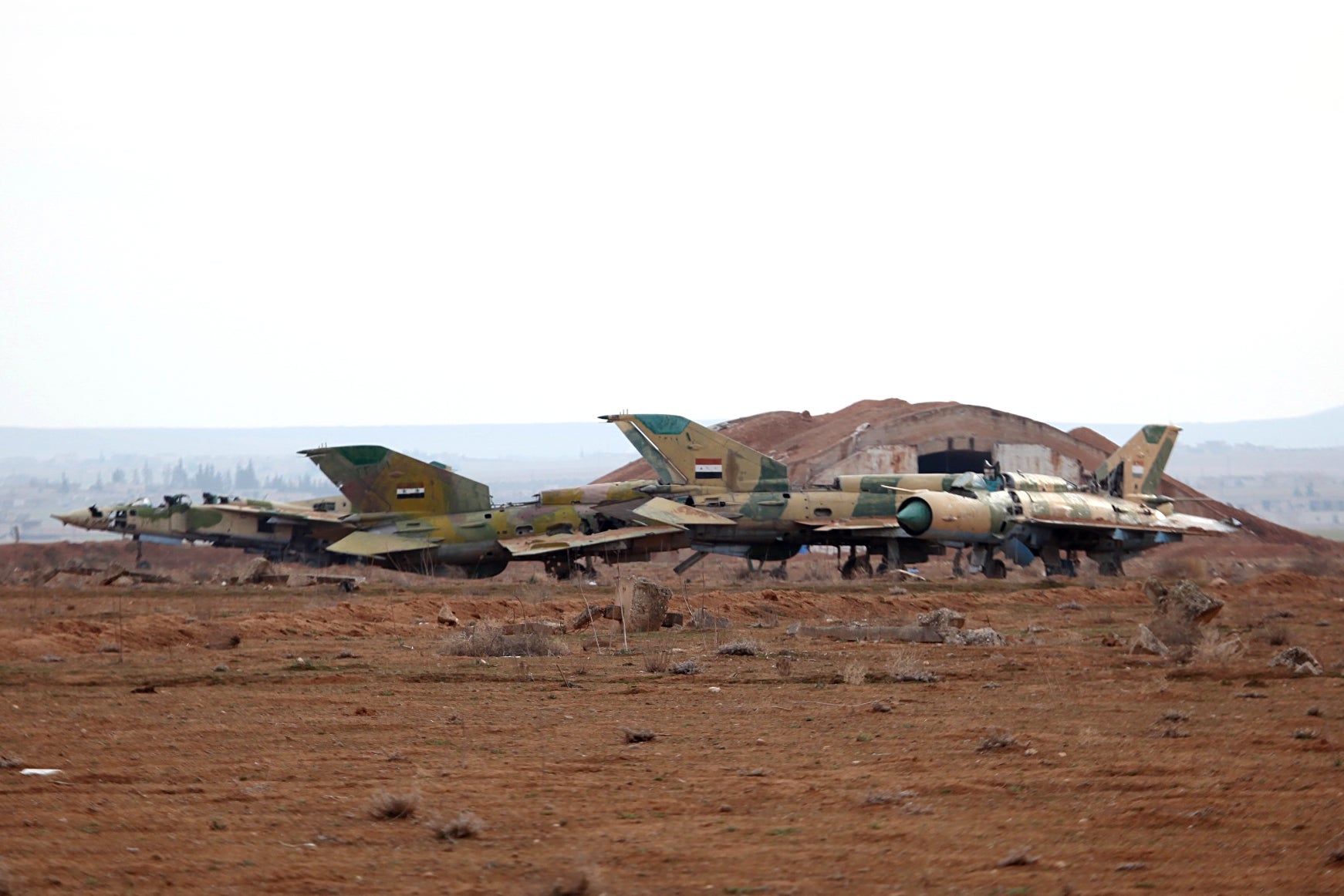 A picture taken on January 21, 2018 shows damaged Syrian air force fighter planes at the Abu Duhur military airport area in Syria's Idlib province.