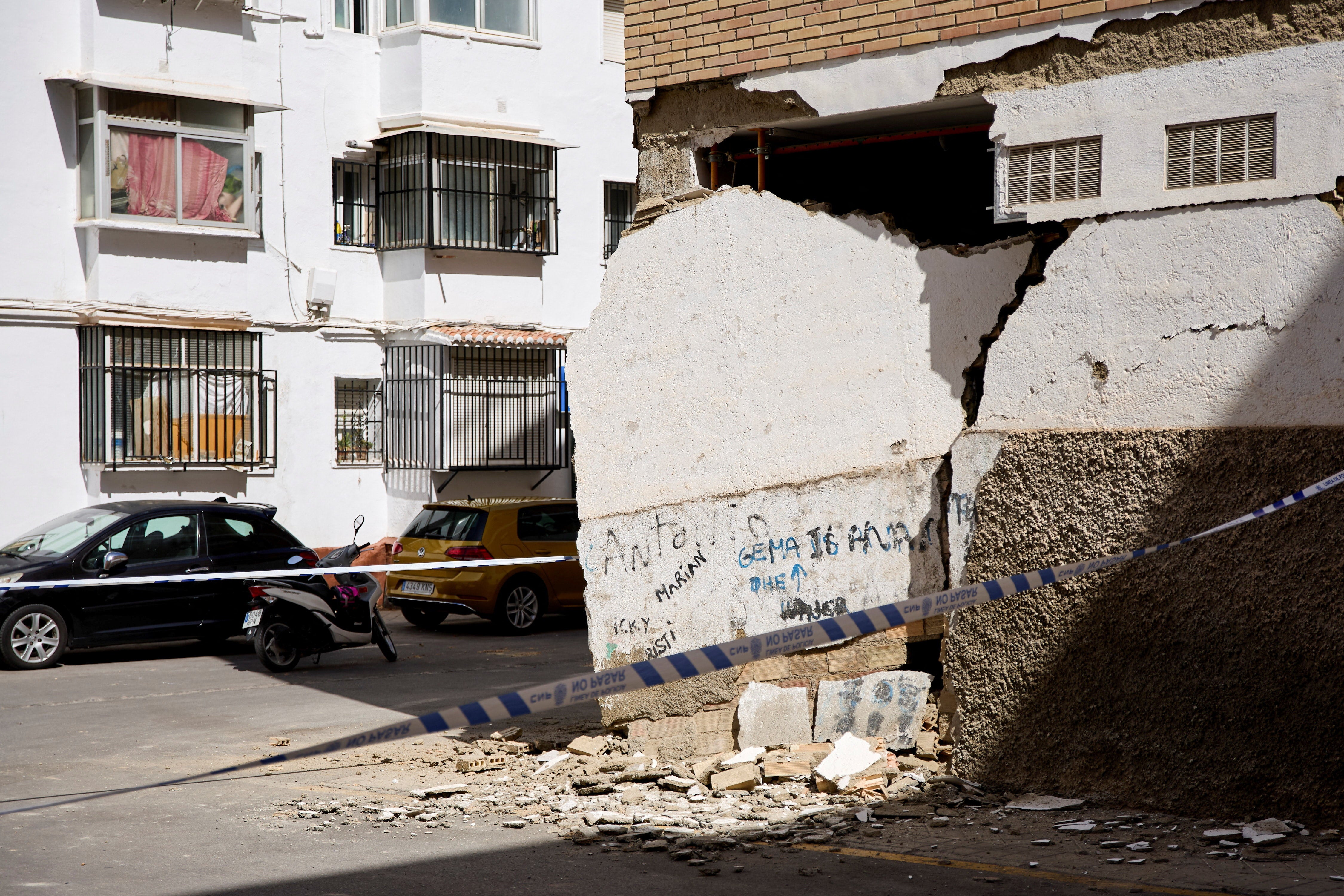 A damaged wall is cordoned off in the aftermath of an earthquake