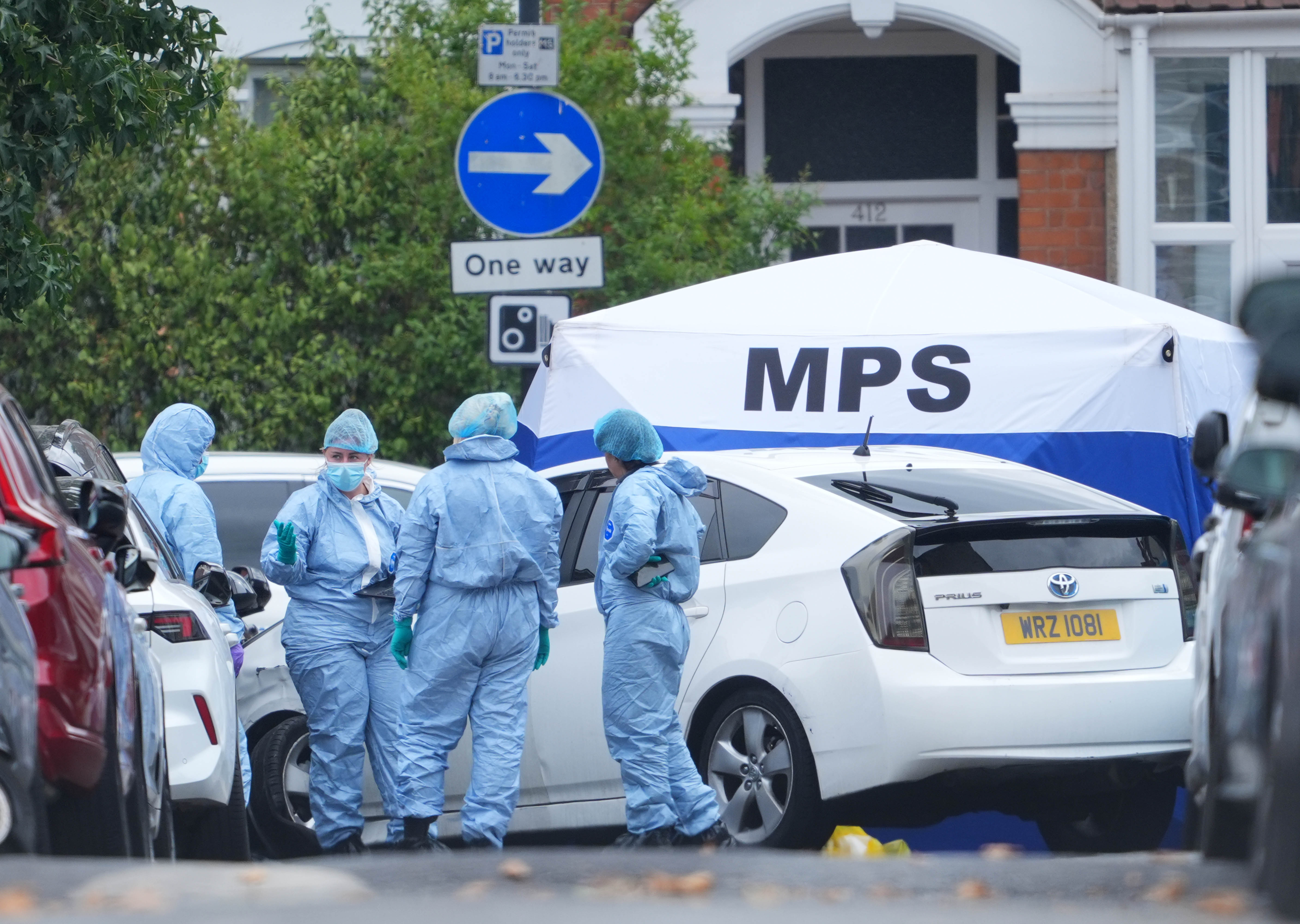 Forensic investigators at the scene on St Bartholomew's Road, Newham, east London, where Masum Miah was found inside a vehicle with gunshot wound