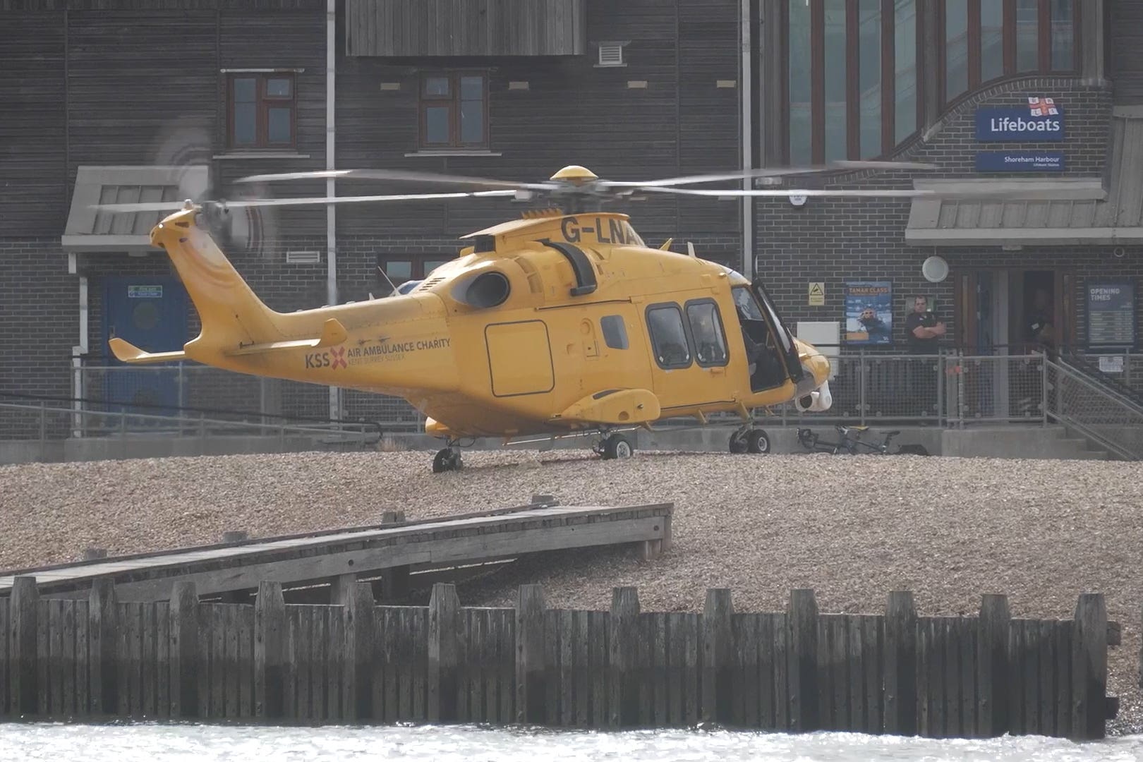 Emergency services respond to four people in water near Shoreham as three family members die; public urged to stay clear of the area.
