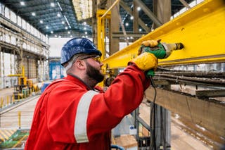 A shipyard worker at Harland & Wolff welding materials in the fabrication hall. (Rud Pederson handout)