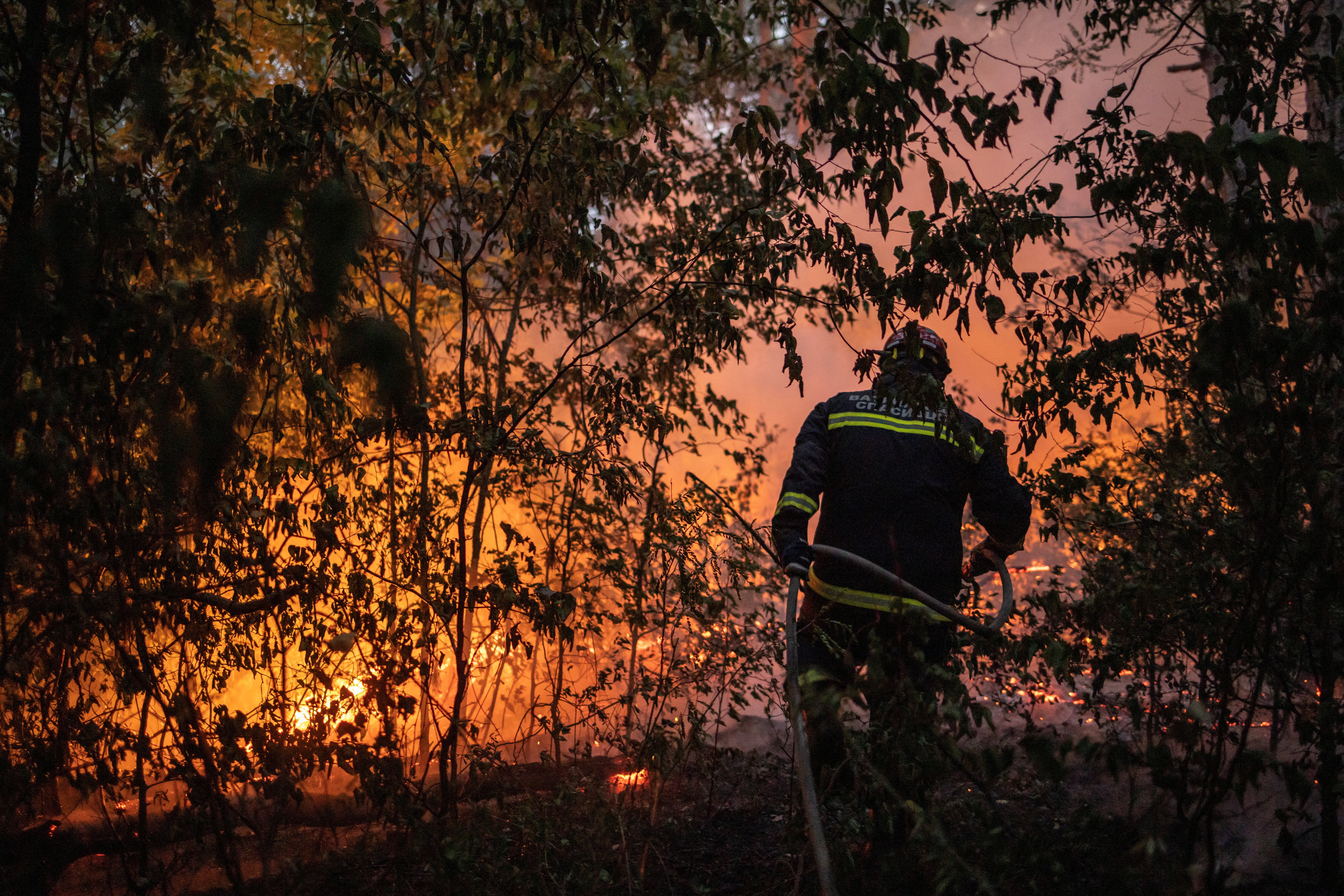 A firefighter battles a wildfire in Deliblatska Pescara, Serbia