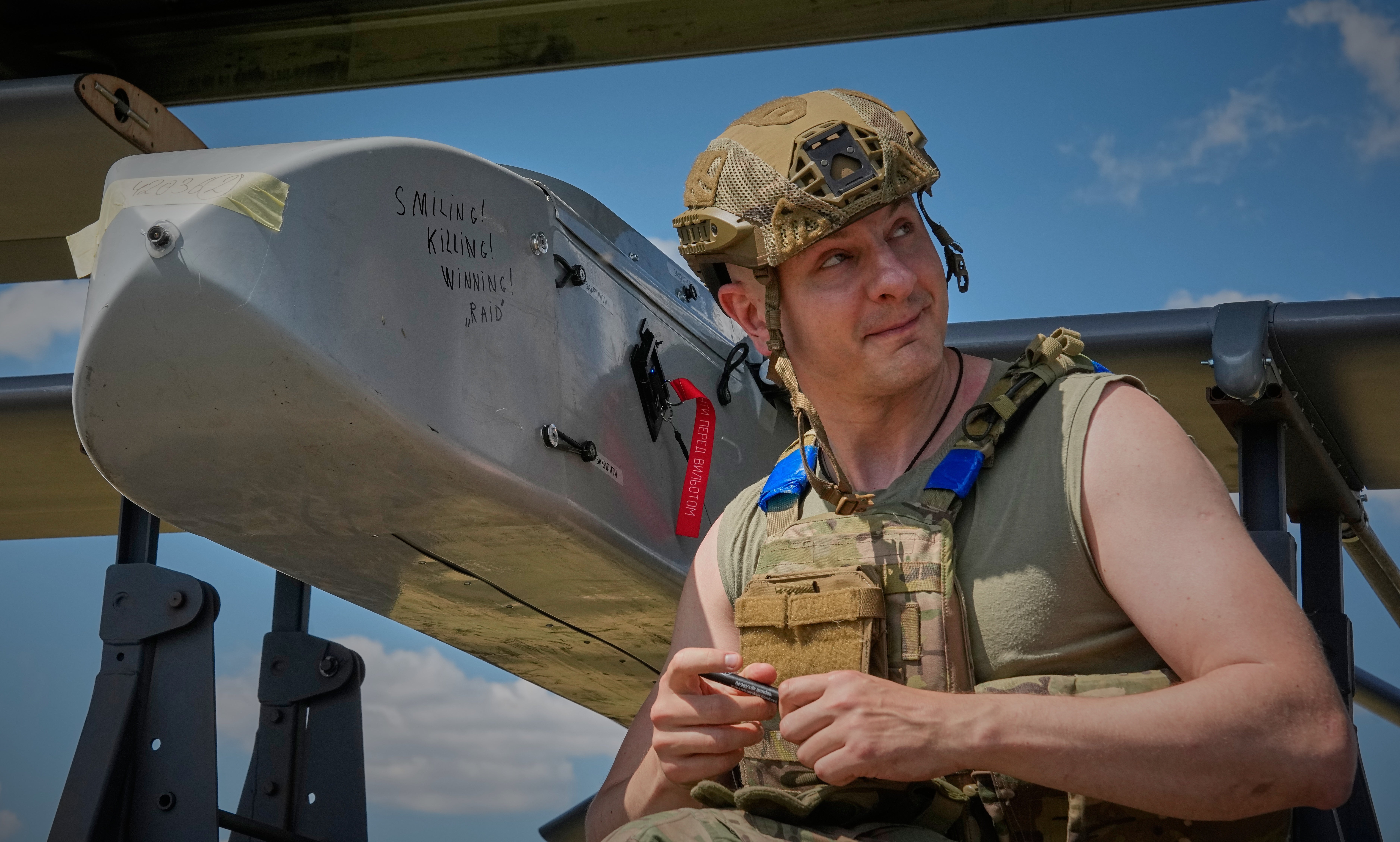 Veyhen Karas writes a message on a drone