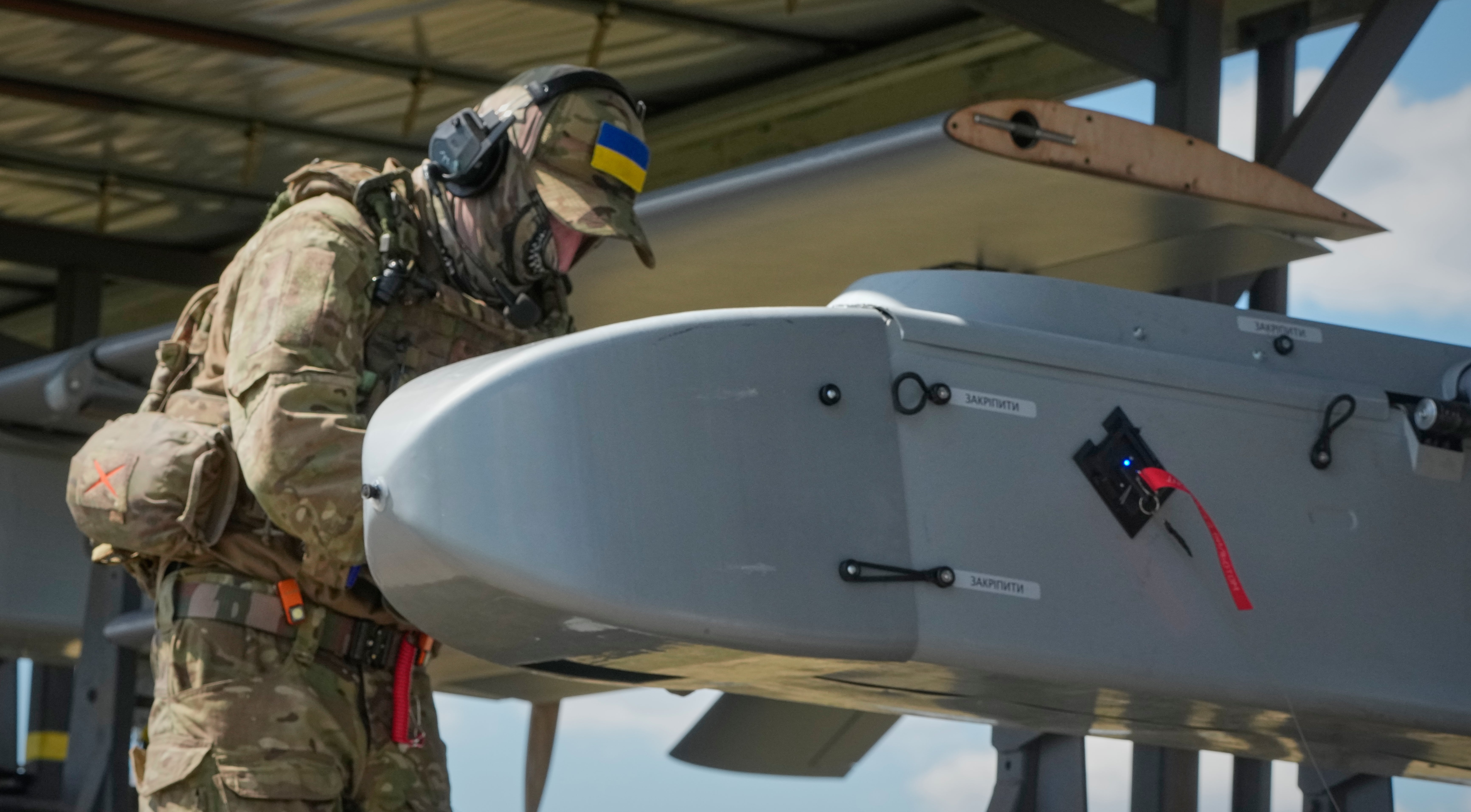 A soldier of Ukraine's 413th Separate Regiment of Unmanned Systems ‘Raid’ prepares an FP-1 long-range attack drone to be launched on a deep-strike drone mission to hit Russian targets