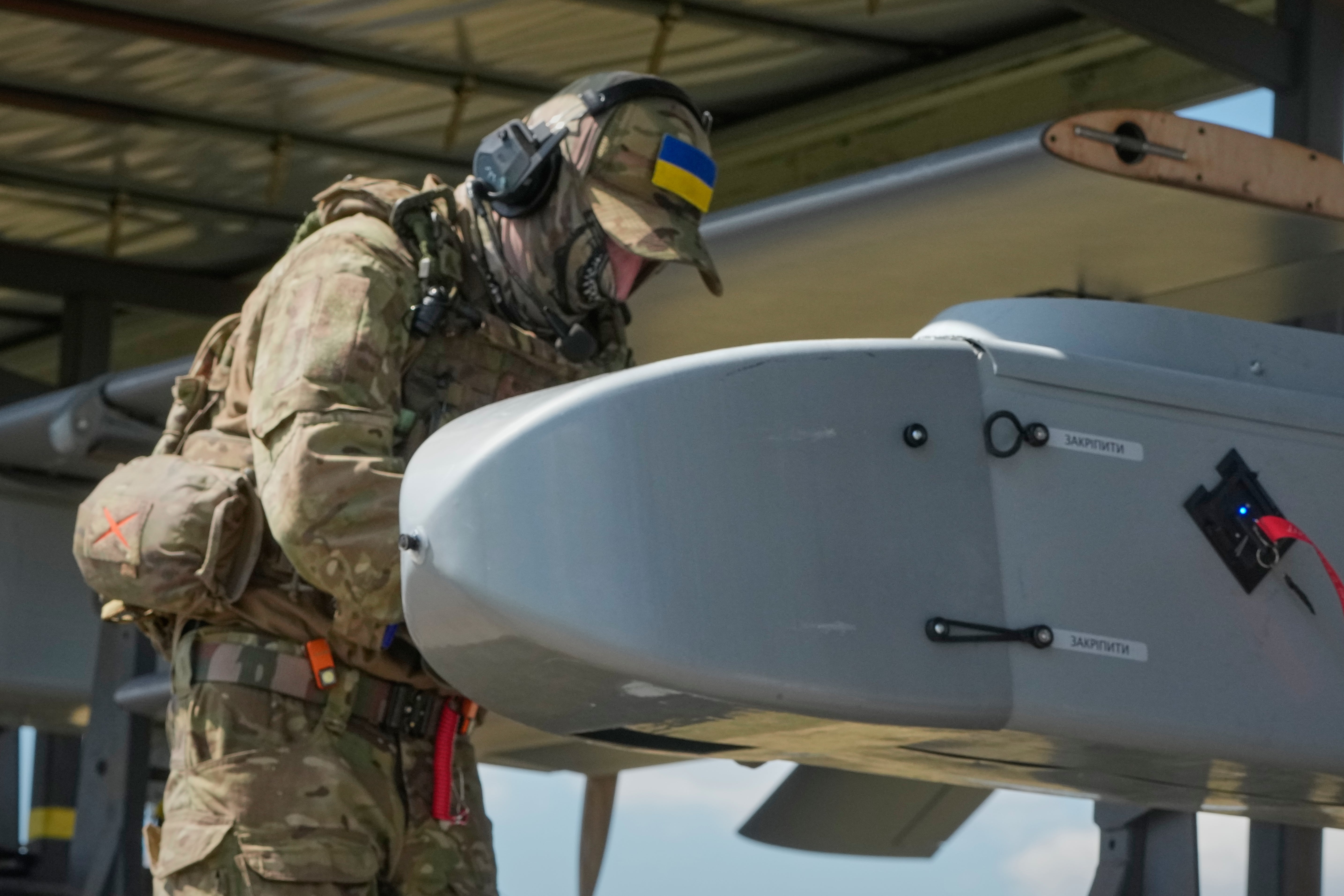 A soldier of Ukraine's 413th Separate Regiment of Unmanned Systems ‘Raid’ prepares an FP-1 long-range attack drone to be launched on a deep-strike drone mission to hit Russian targets (AP)