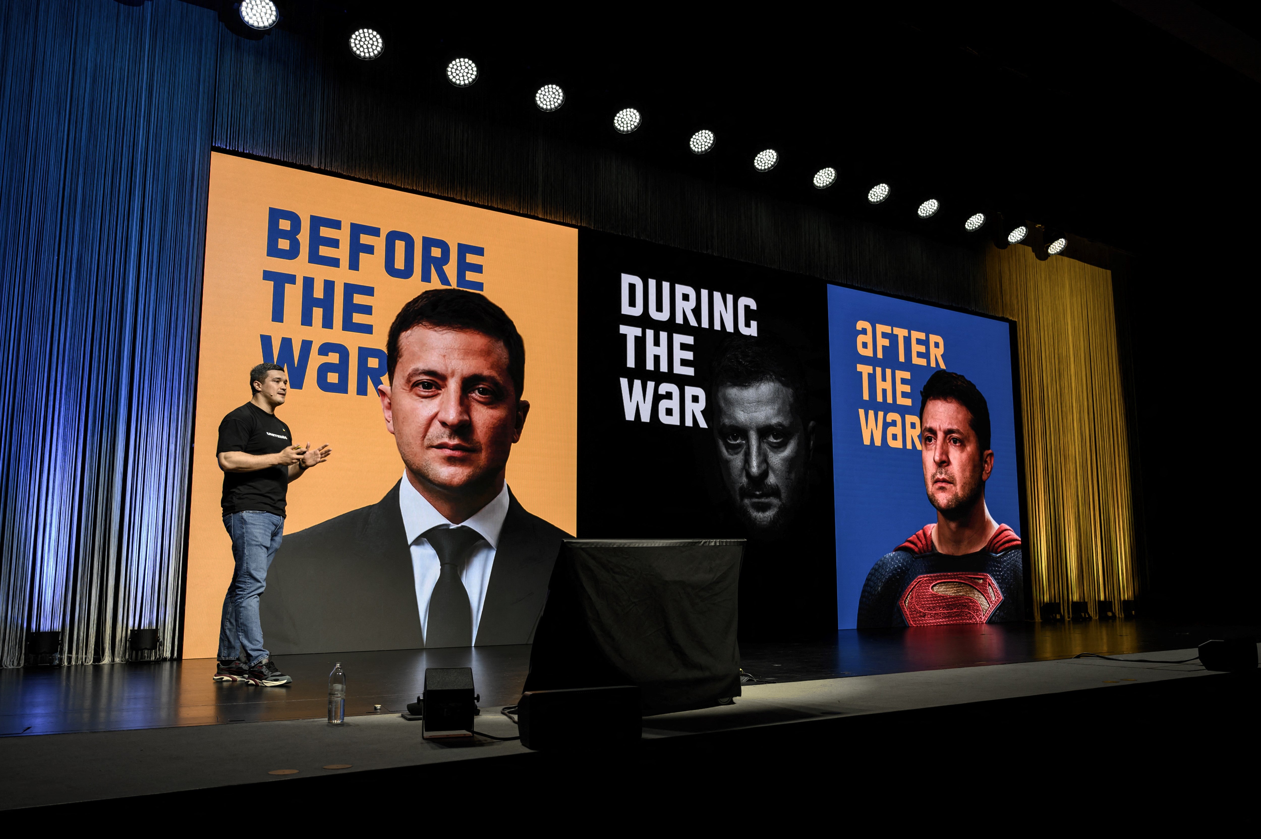 Mykhailo Fedorov delivers a speech next to pictures of Volodymyr Zelensky during of a two-day International conference on reconstruction of Ukraine (AFP/Getty)