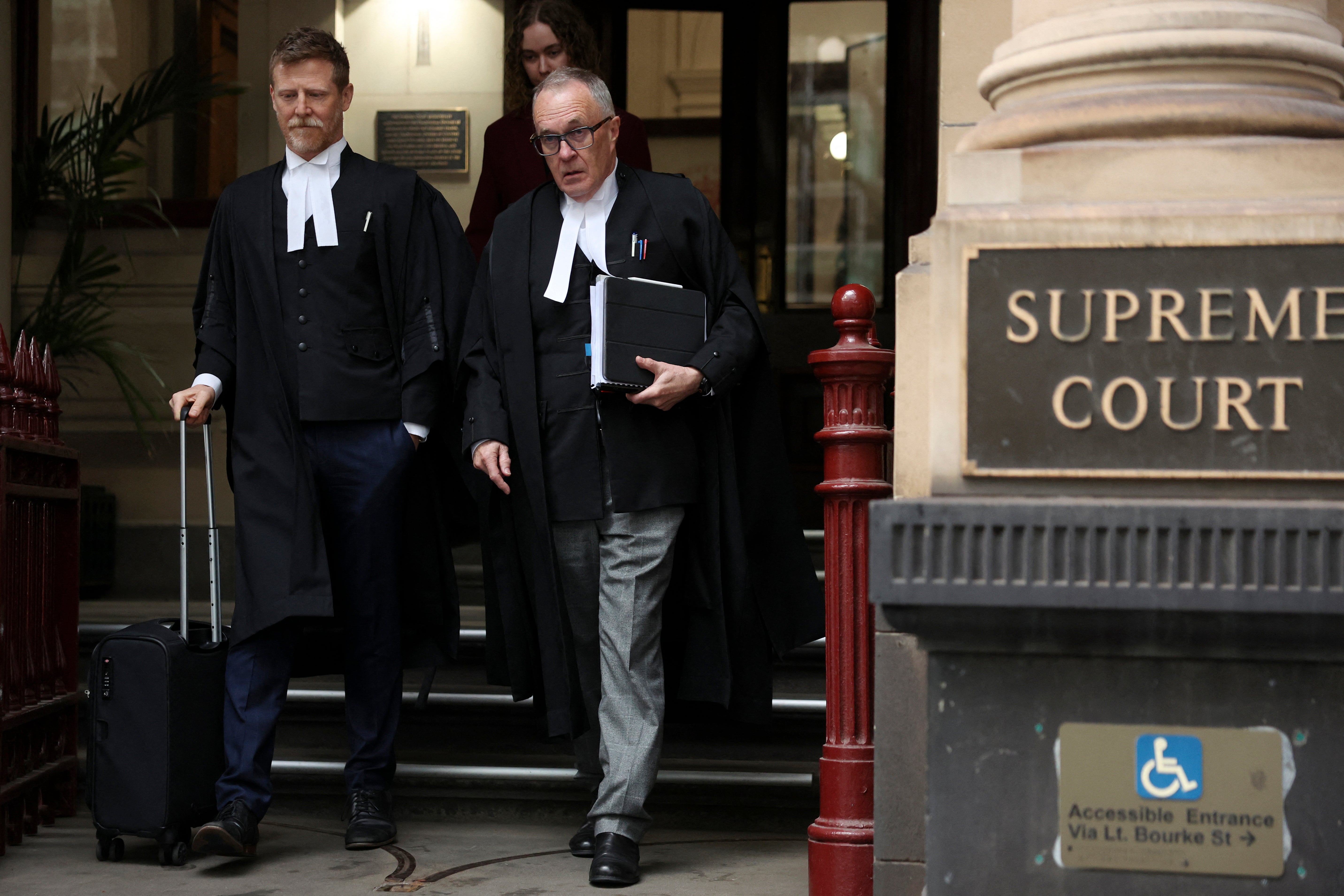 Brendan Kissane (R), Victoria's Director of Public Prosecutions, leaves the Supreme Court of Victoria in Melbourne on 19 August 2026