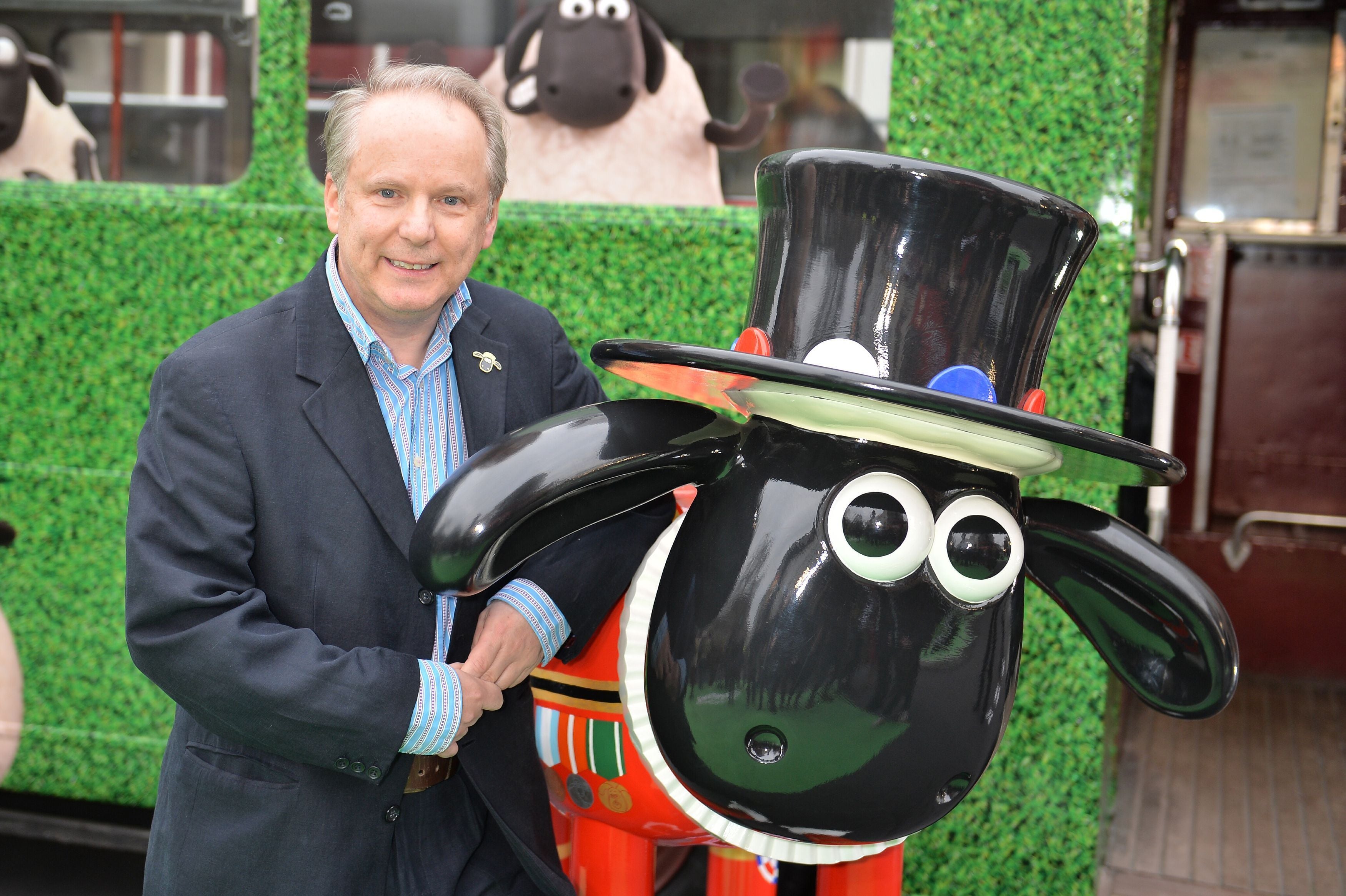 Nick Park, the creator of Shaun the Sheep, with a statue of the titular character (PA Archive)