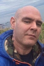 Police launch double murder investigation after two men found stabbed to death in Glasgow flat; manhunt underway