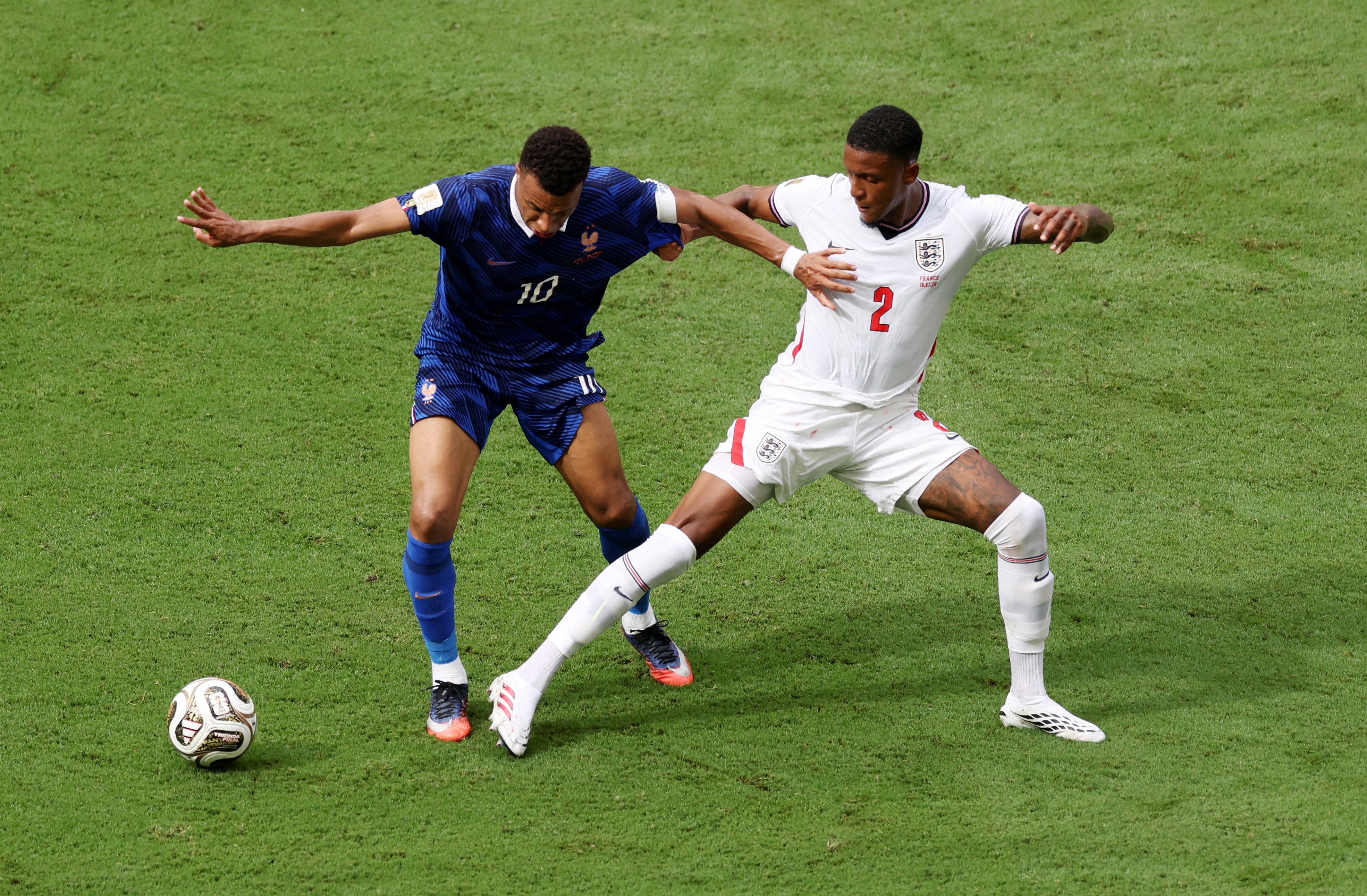 Kylian Mbappe of France and Ezri Konsa of England compete for the ball