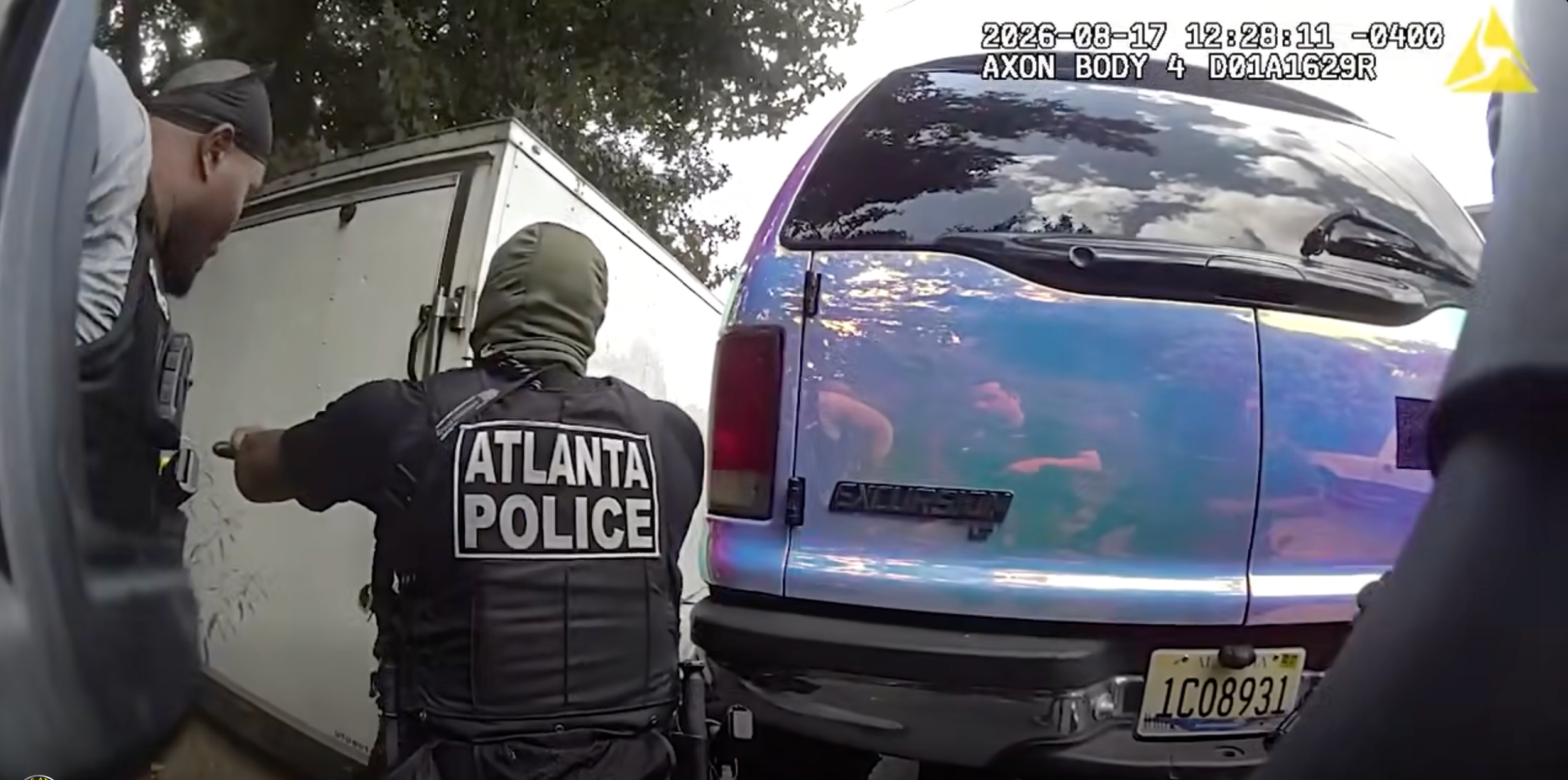 Police body cam footage shows officers breaking the lock on the tow trailer and opening it to find Brown and the two girls (Atlanta Police Department)