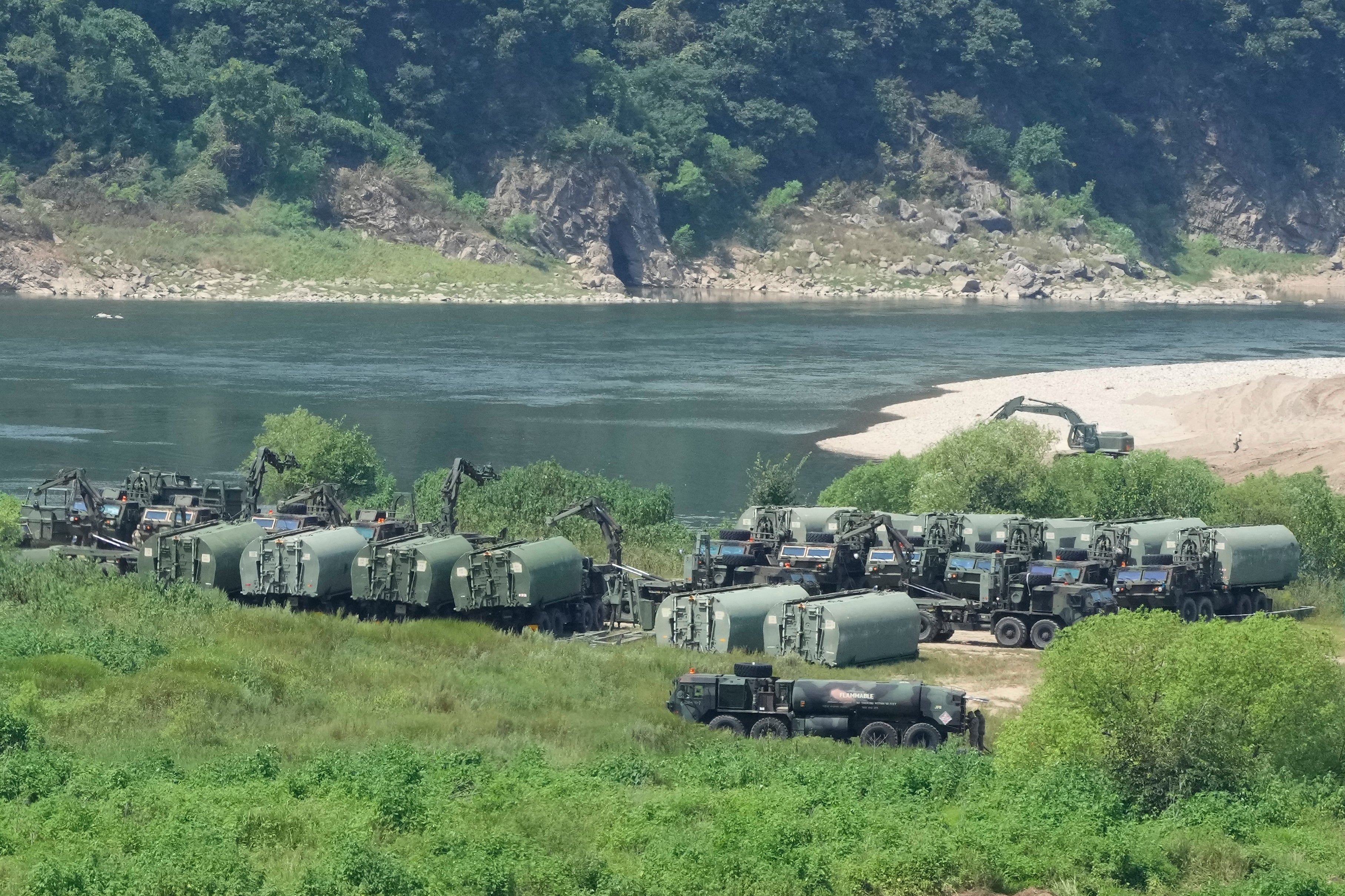 The U.S. Army's armored vehicles gather to cross a river at a training field in Yeoncheon, South Korea, near the border with North Korea