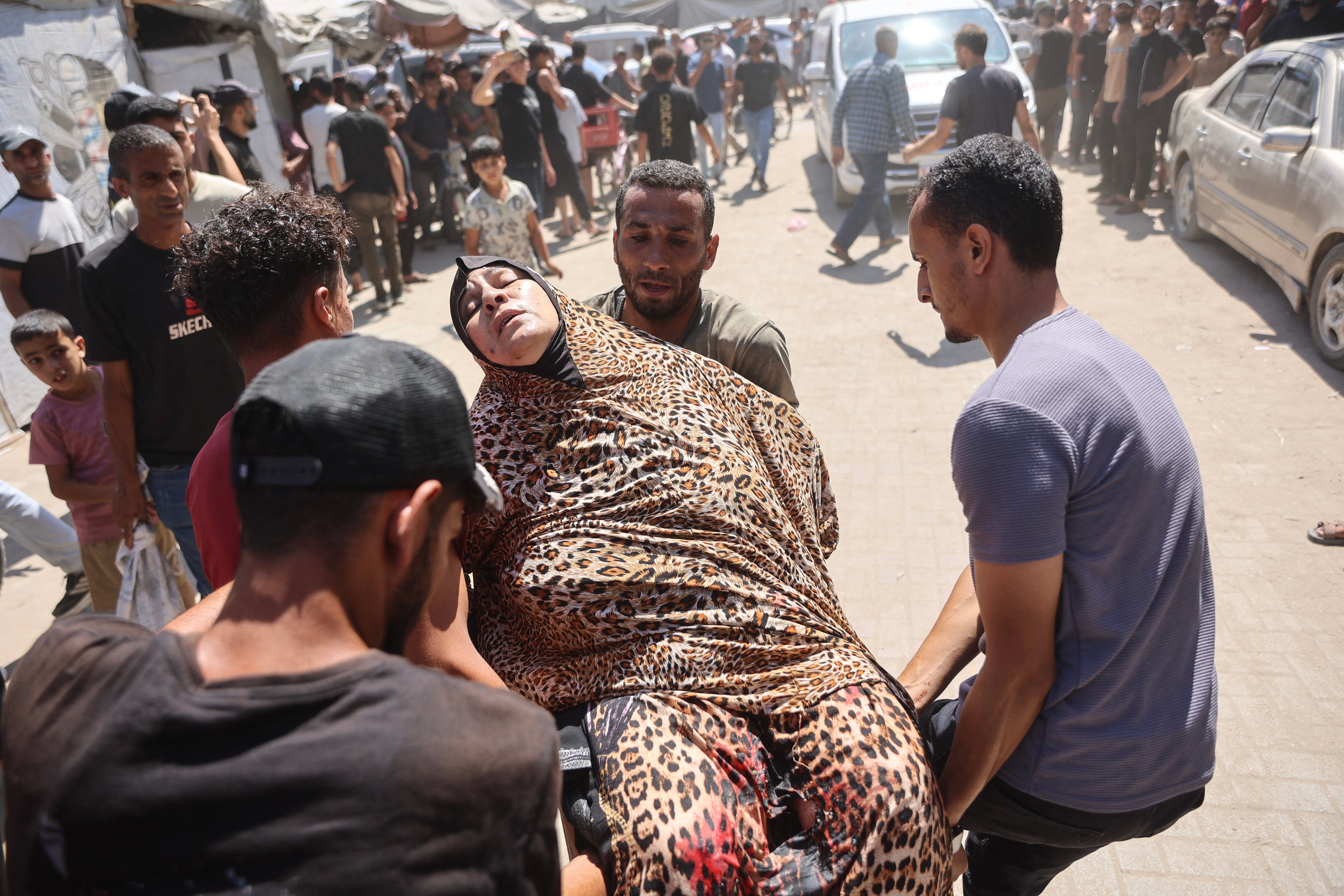 Palestinians carry a victim away from the site of Israel’s strike on Nuseirat (AFP/Getty)
