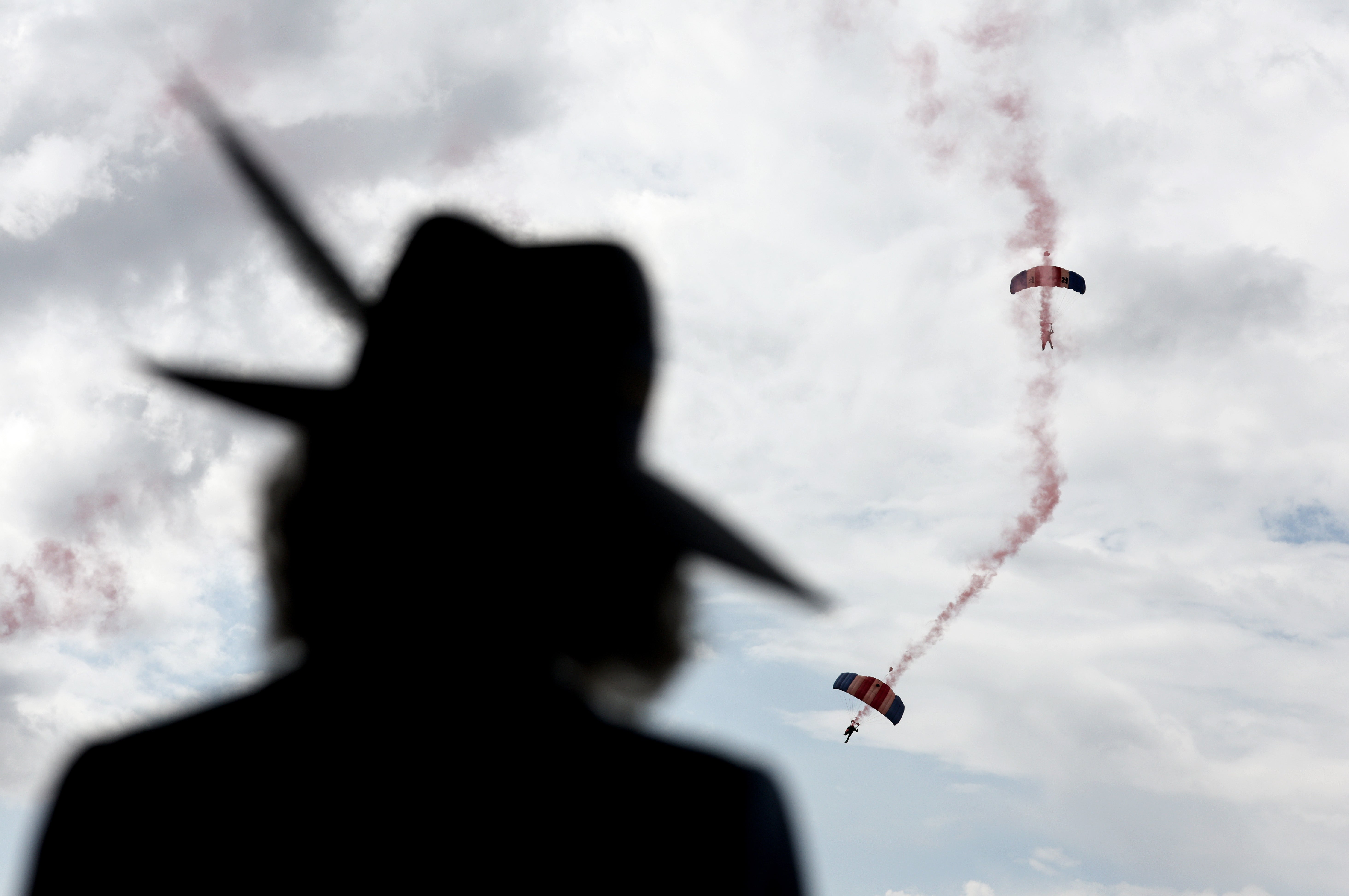 Camilla watches as the RAF Falcons Parachute Display Team drop onto the course (Chris Jackson/PA) (PA Wire)