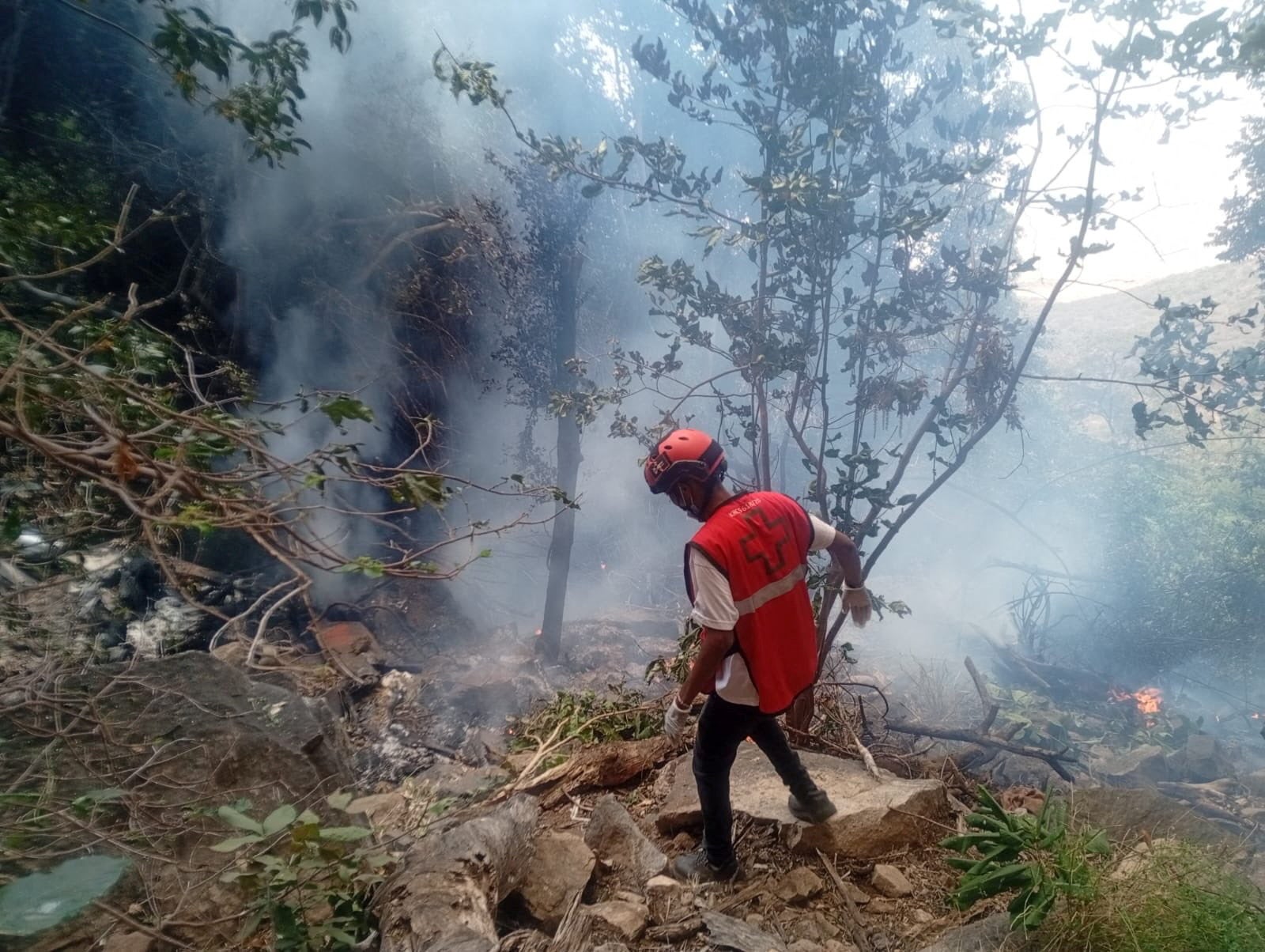 A rescue official works at the site of the crash that caused multiple casualties, according to the police, in Samburu County, Kenya