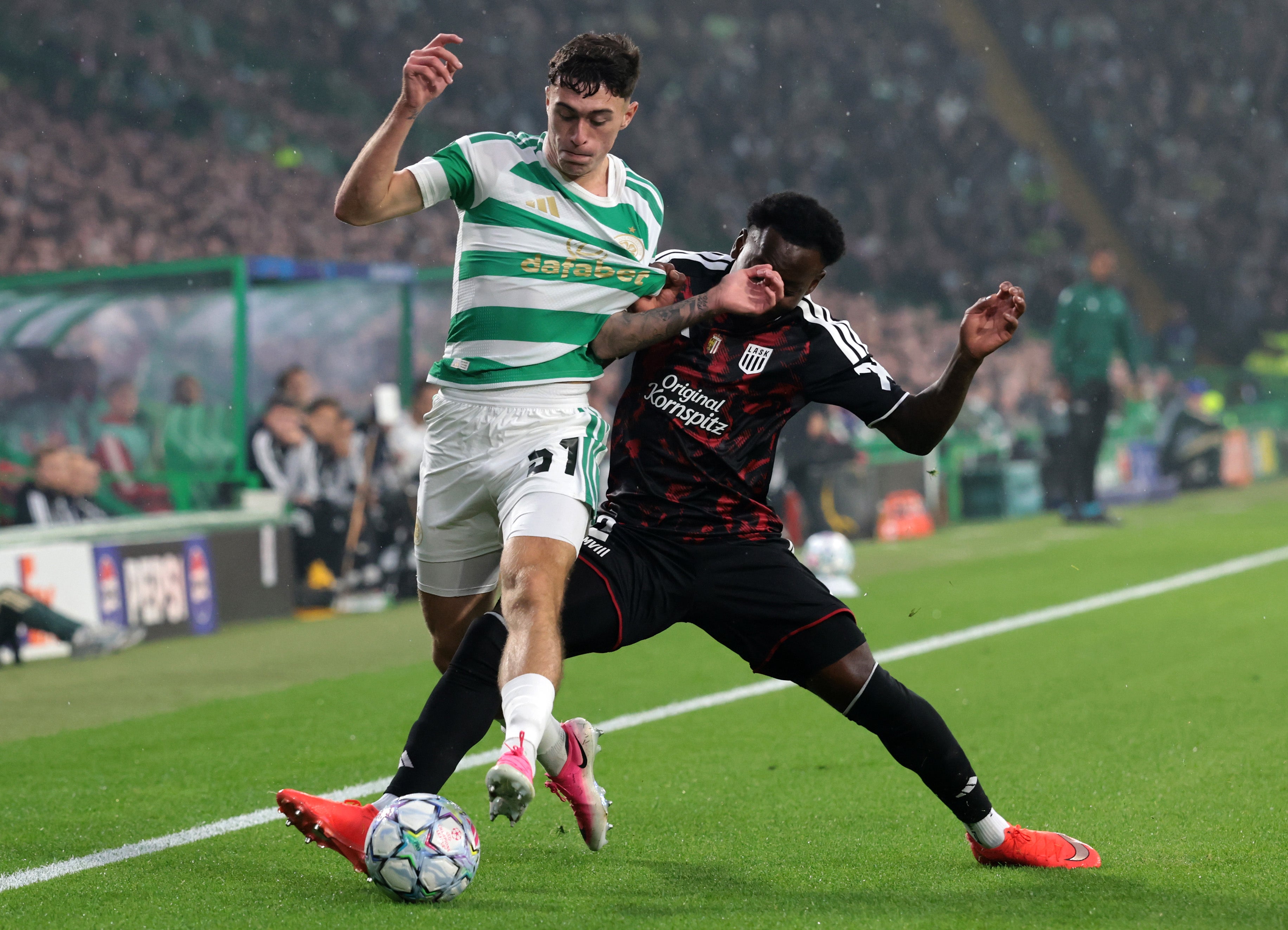 Colby Donovan of Celtic is challenged by George Bello of LASK