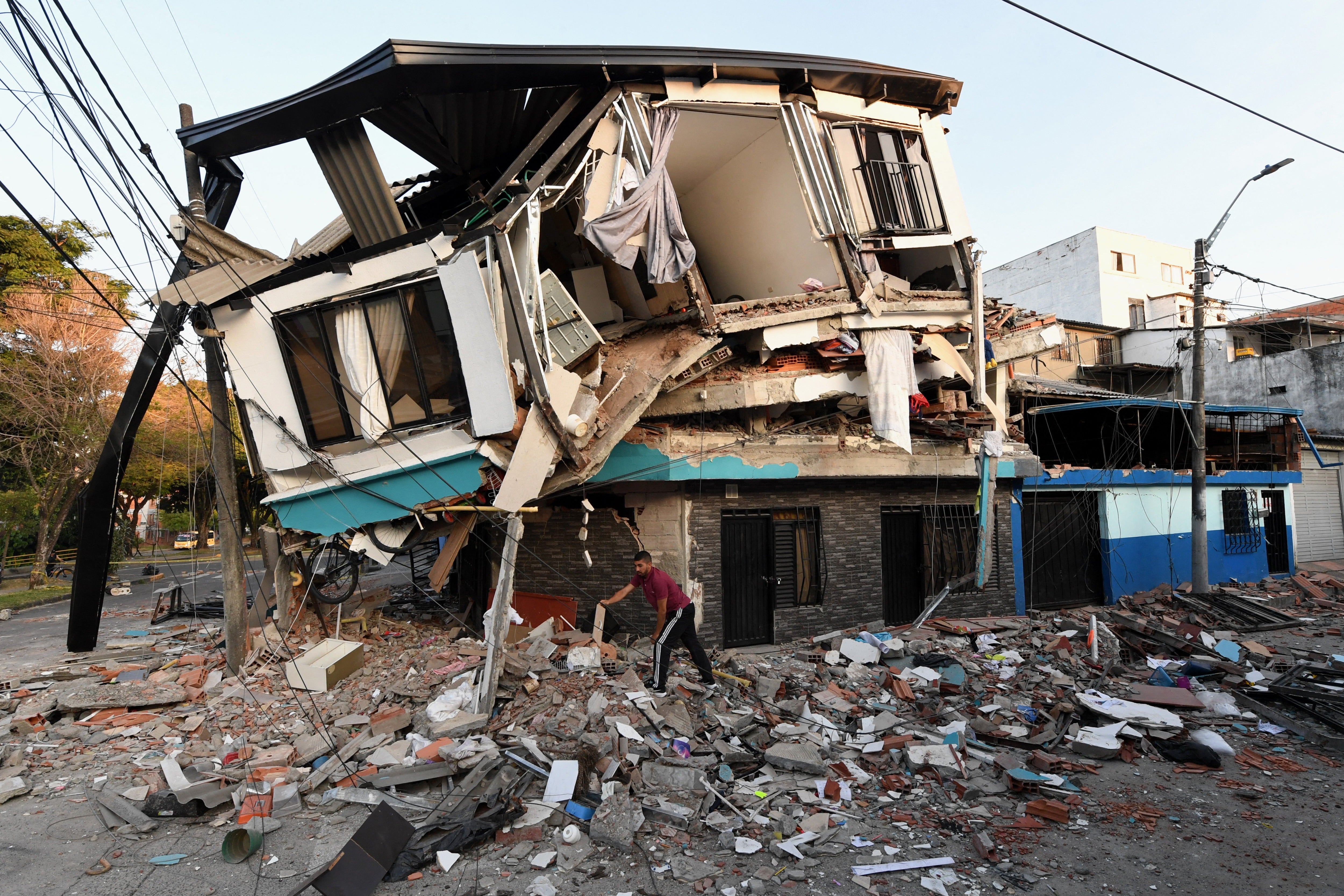 A man removes the debris of a collapsed house after an earthquake in Pereira, Colombia, earlier this month. The earthquake there was one of the country’s largest in year