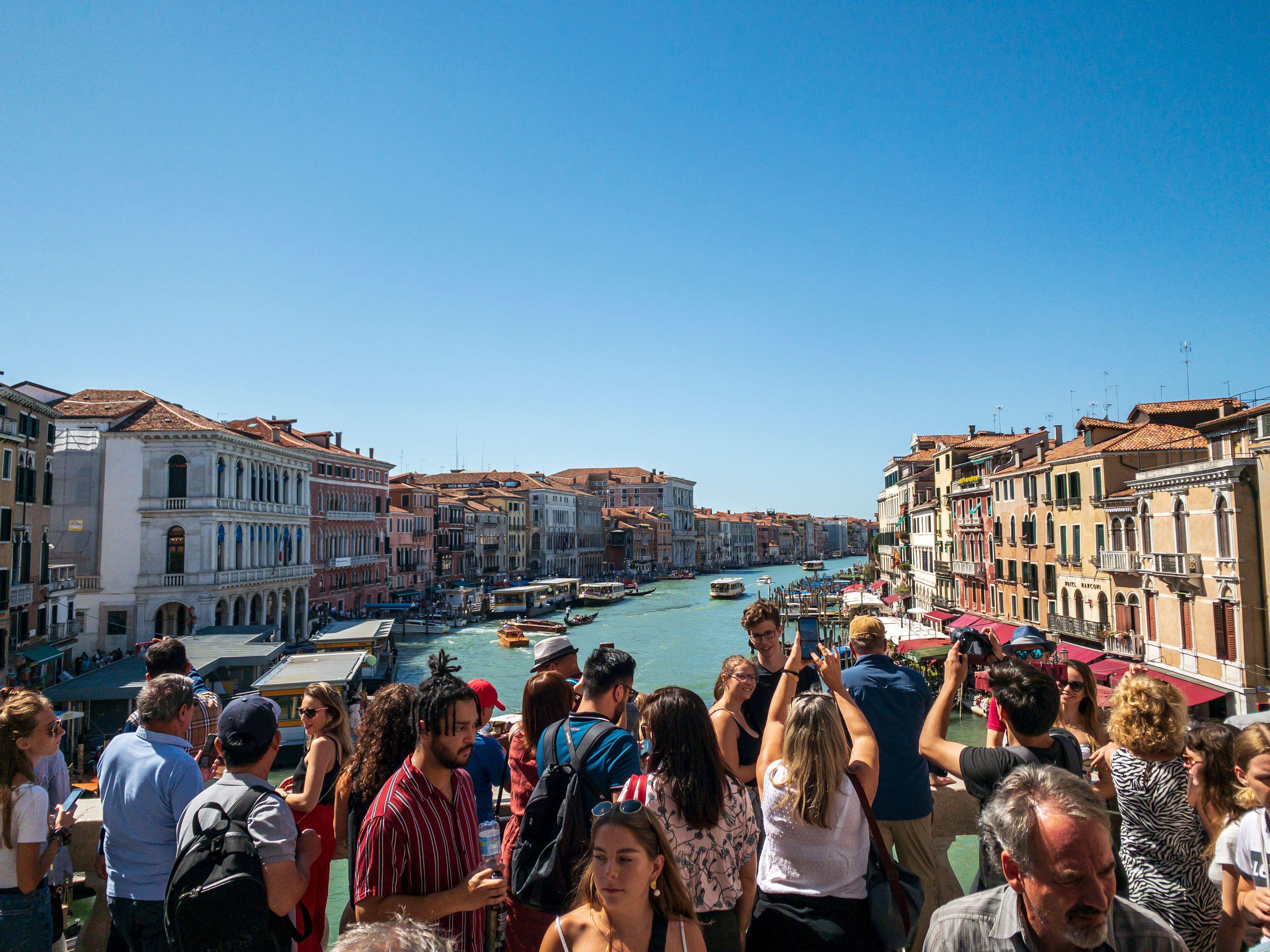 Tourists take photos of the Grand Canal in Venice, Italy