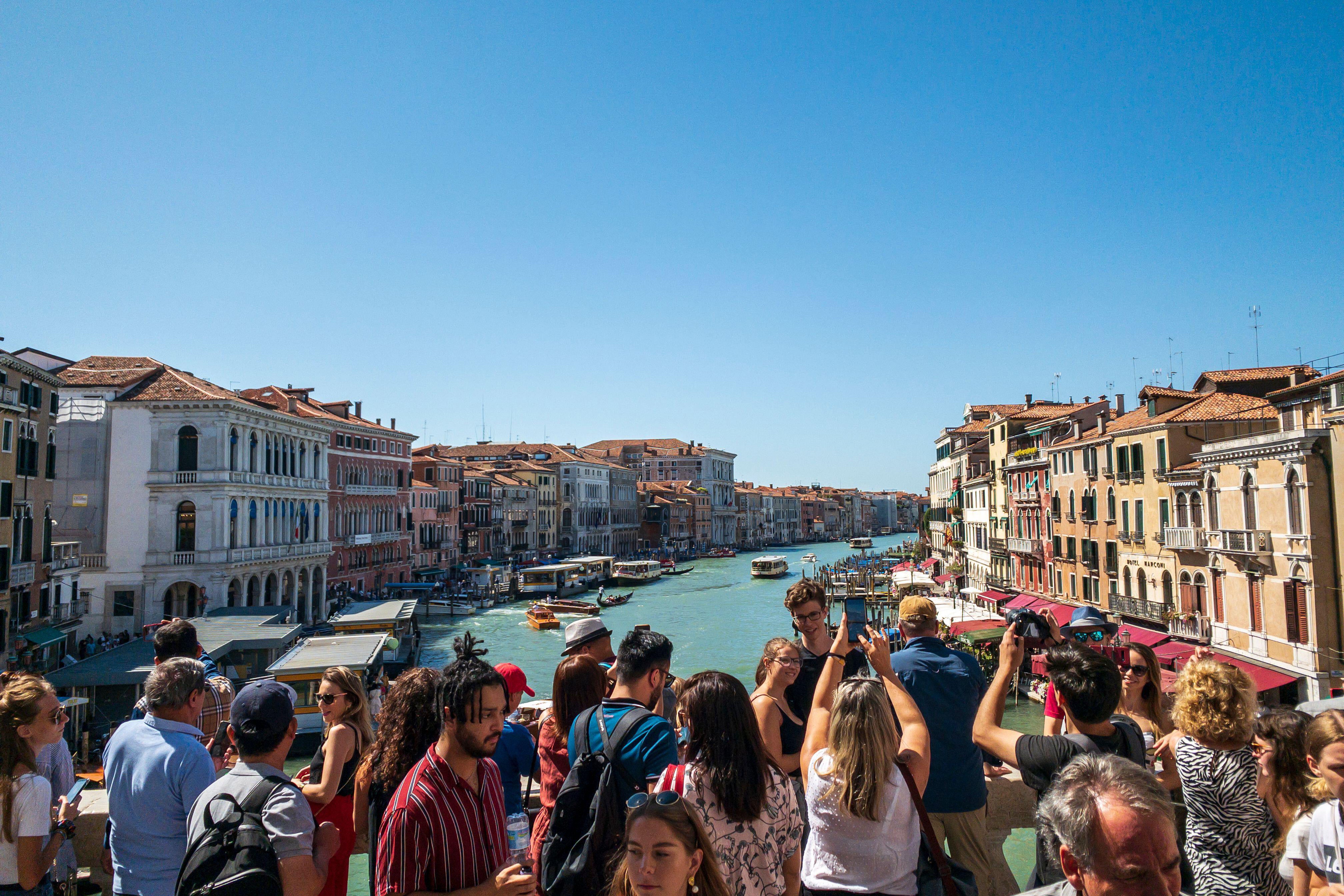 Tourists take photos of the Grand Canal in Venice, Italy (PA)