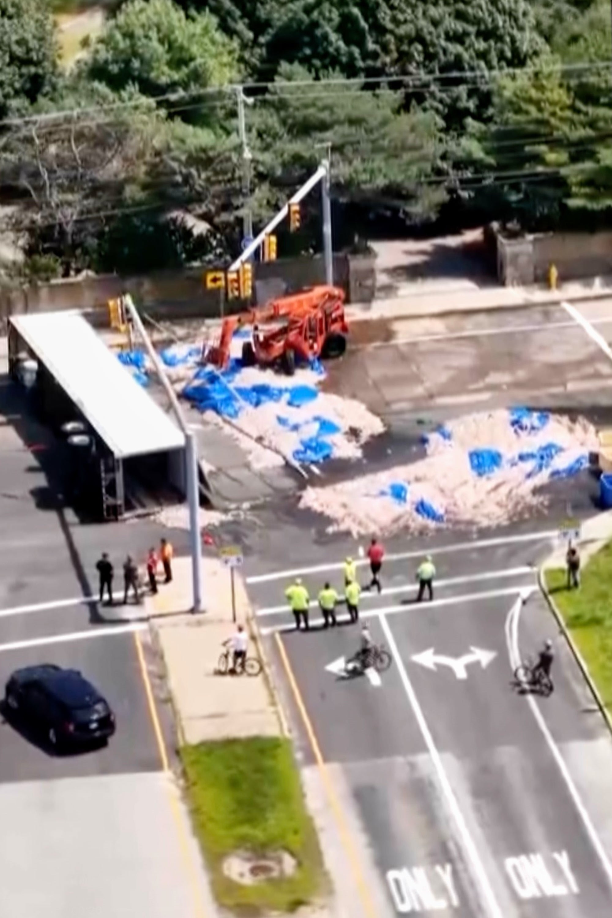 Truckload of squid spills into the street in Rhode Island, creating a smelly mess in the summer heat