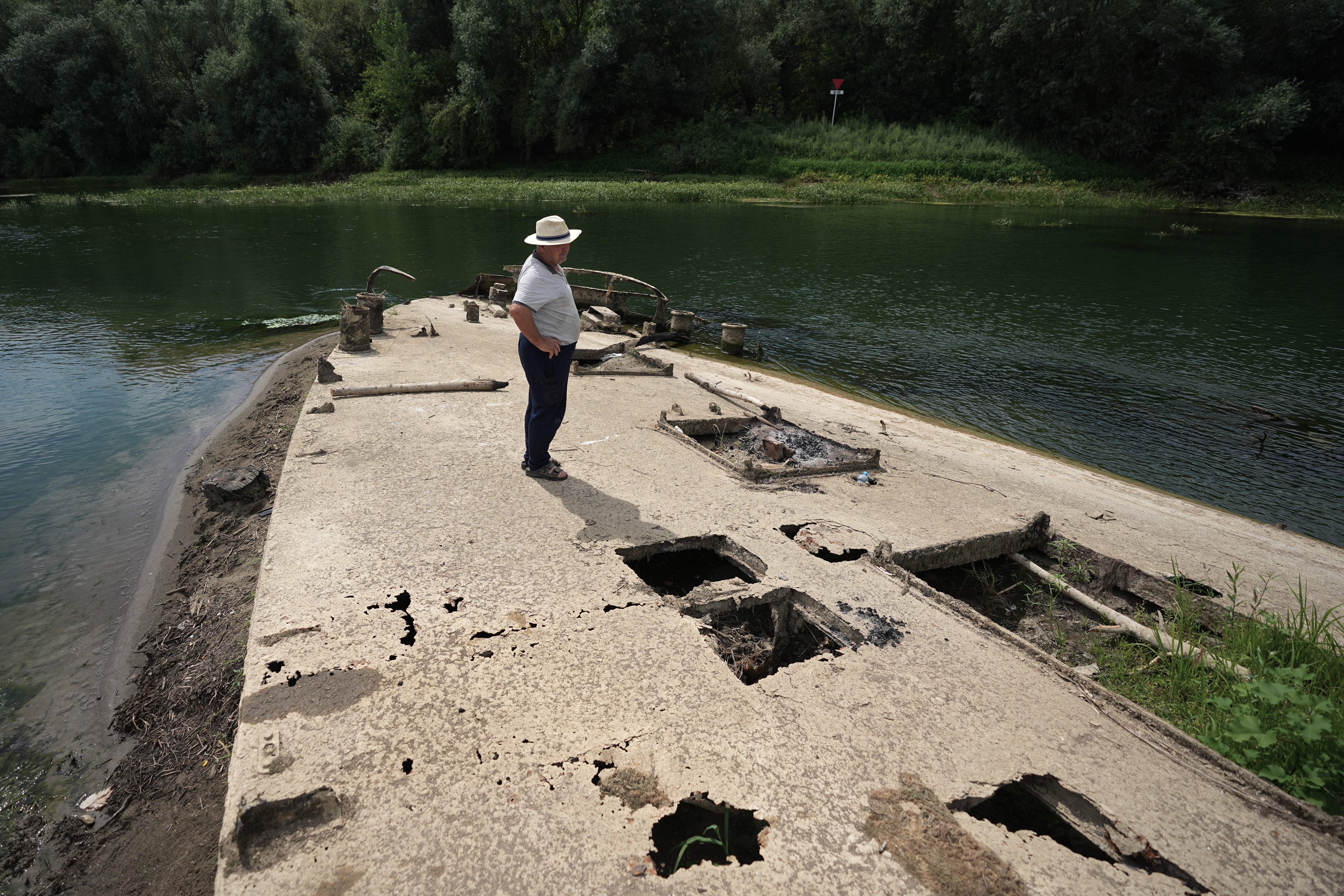 Stanislav Kozenko stands on the wreckage of the old steam boat