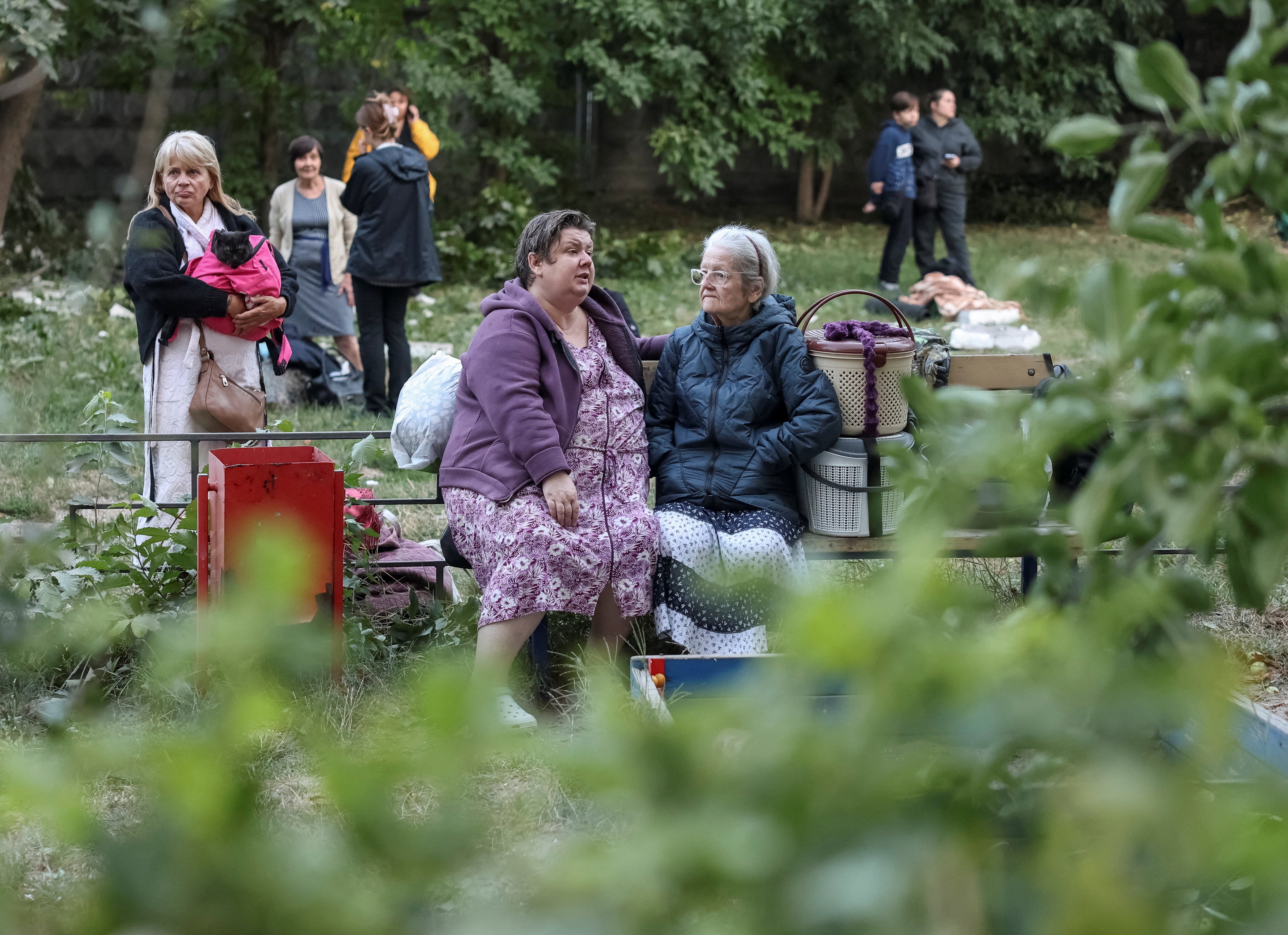 Residents gather at a site of an apartment building destroyed by a Russian missile strike in Kyiv (Reuters)