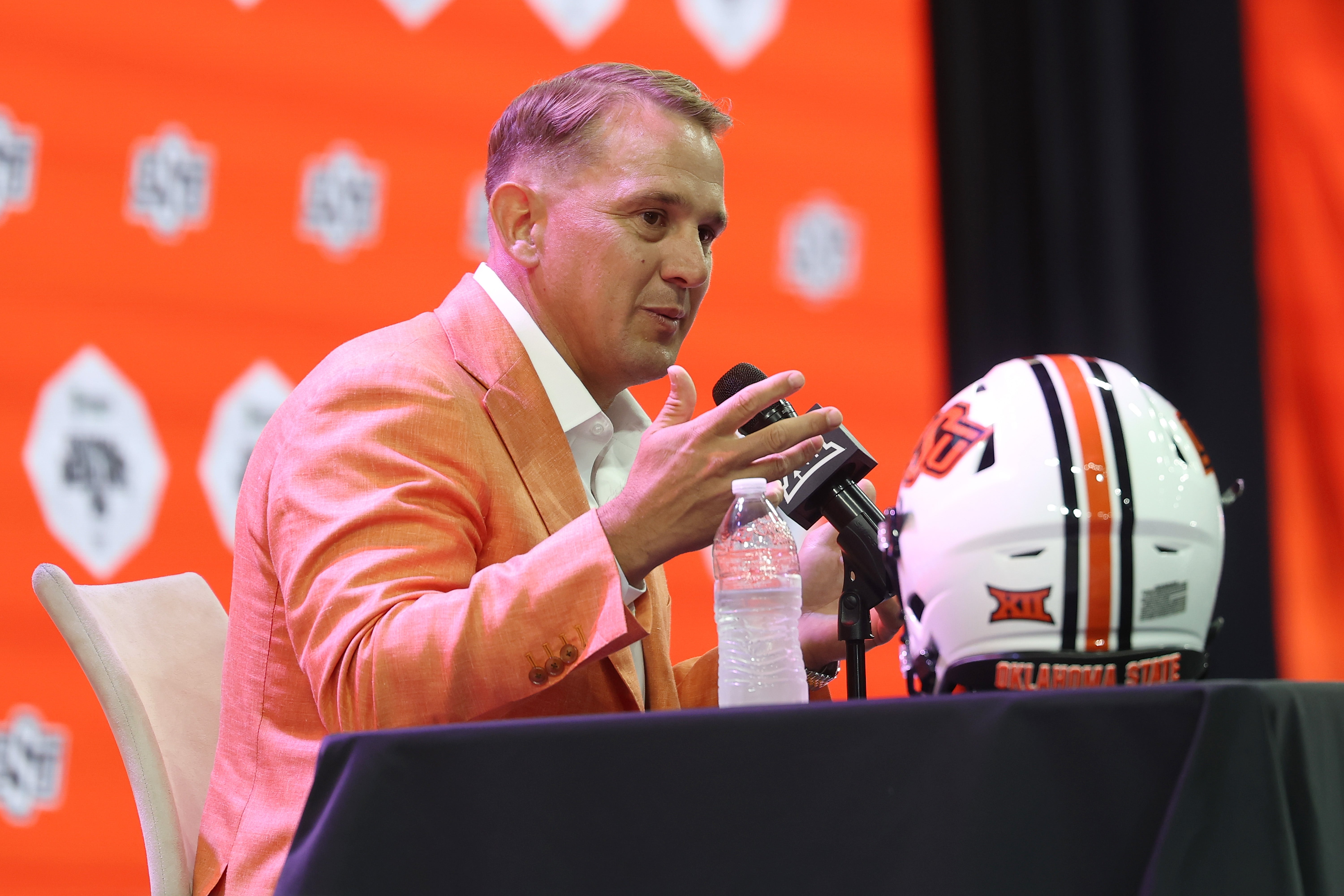 Head coach Eric Morris of the Oklahoma State Cowboys speaks with the media during the Big 12 Media Days at The Ford Center