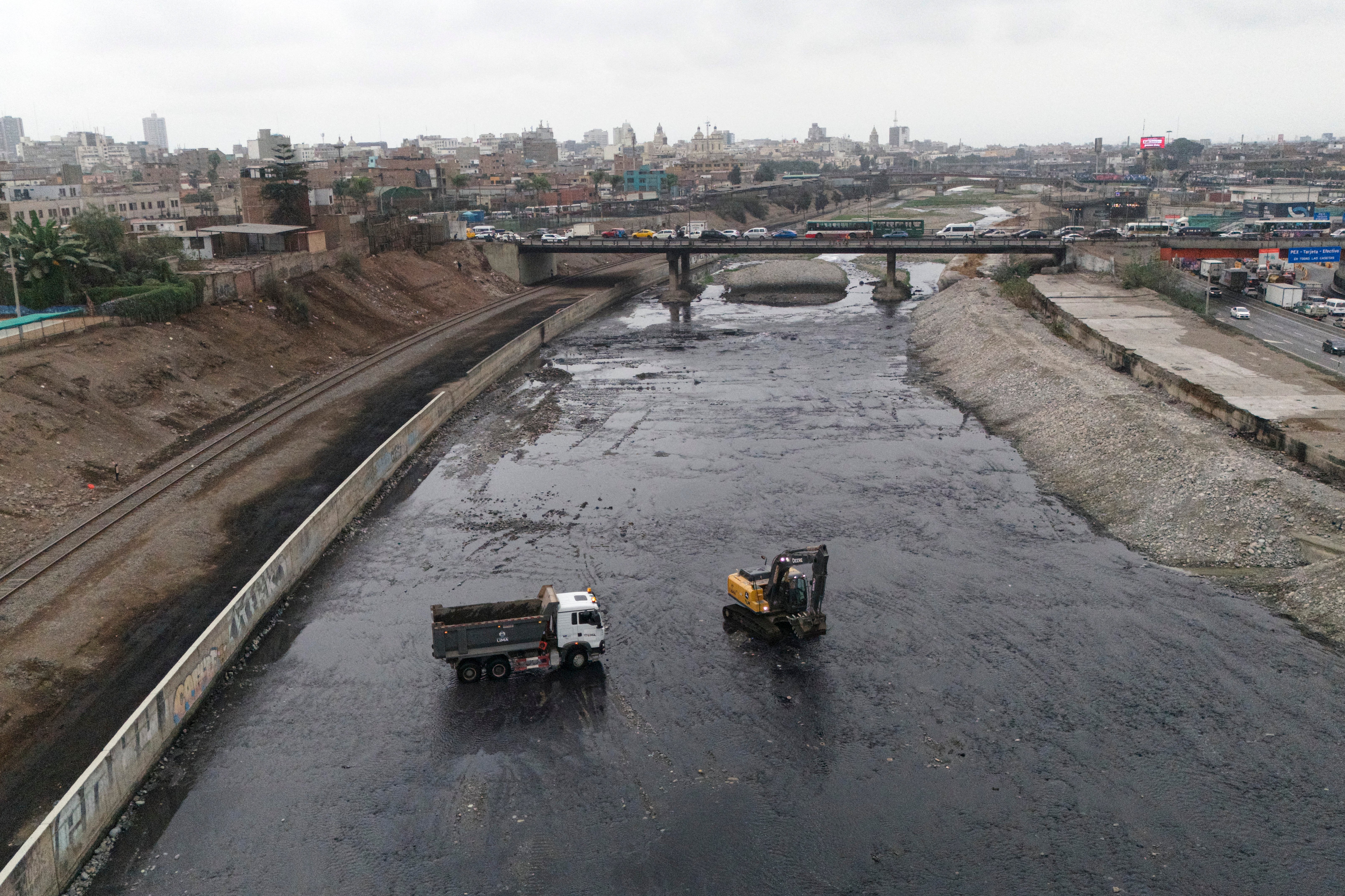This image shows a cleaning and desilting operation on the Rimac river as a preventive measure against the El Niño phenomenon, in Lima on July 9