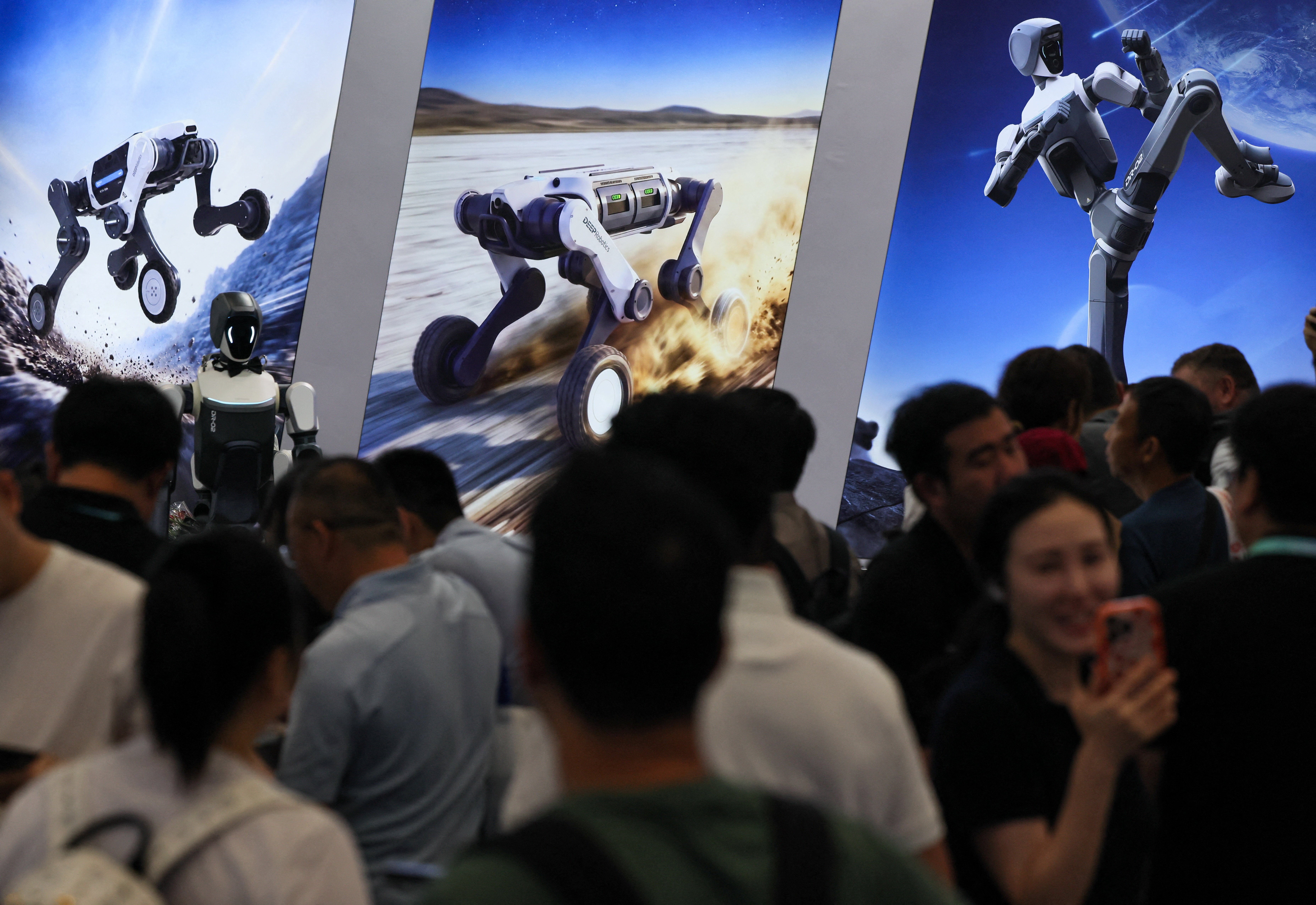 People gather next to Deep Robotics banners promoting the company's robots at the 2026 World Robot Conference, in Beijing, China, August 20, 2026. REUTERS/Maxim Shemetov (Reuters)