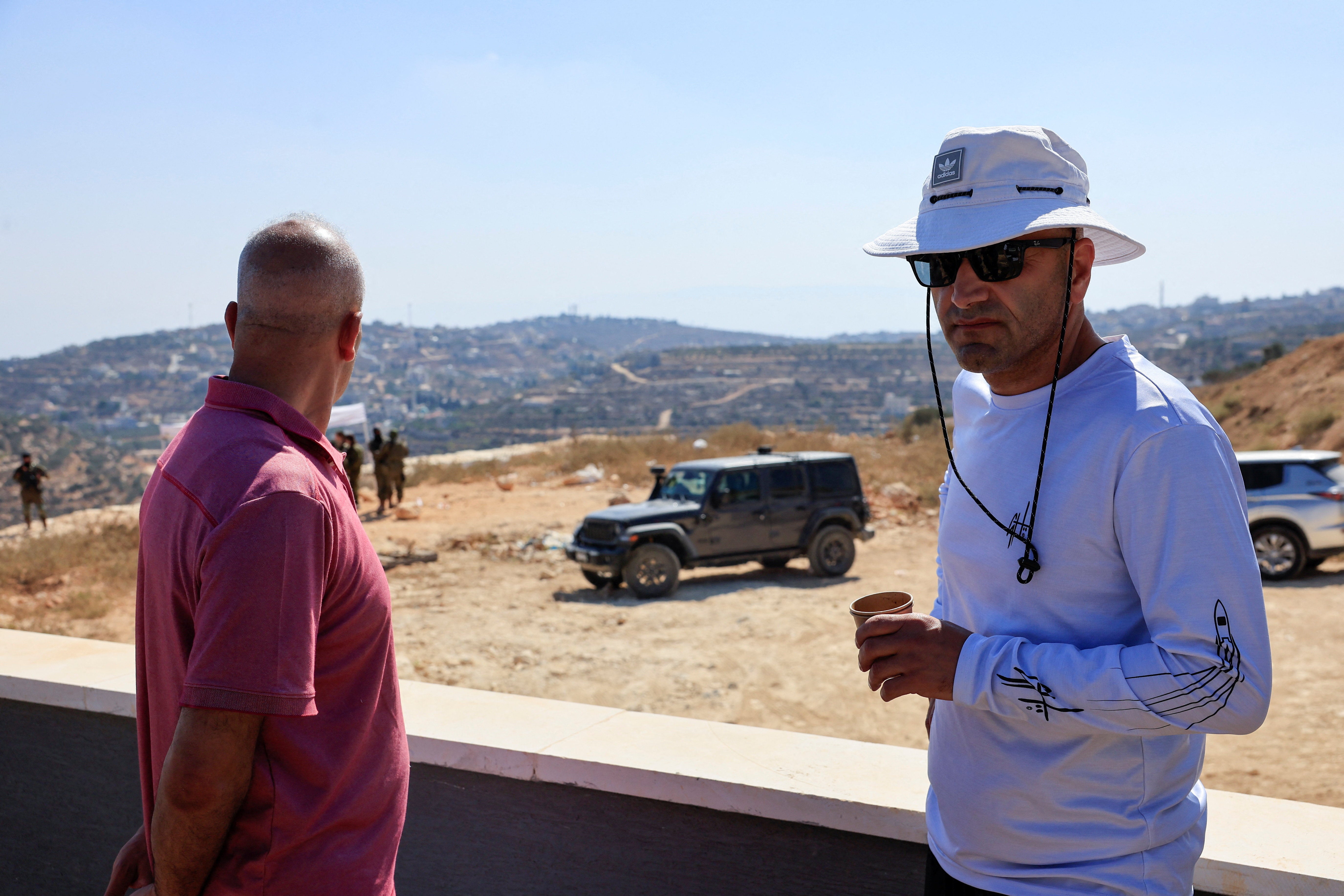Palestinian-American Loui Ridi stands, with his brother Qusai Ridi, outside his home