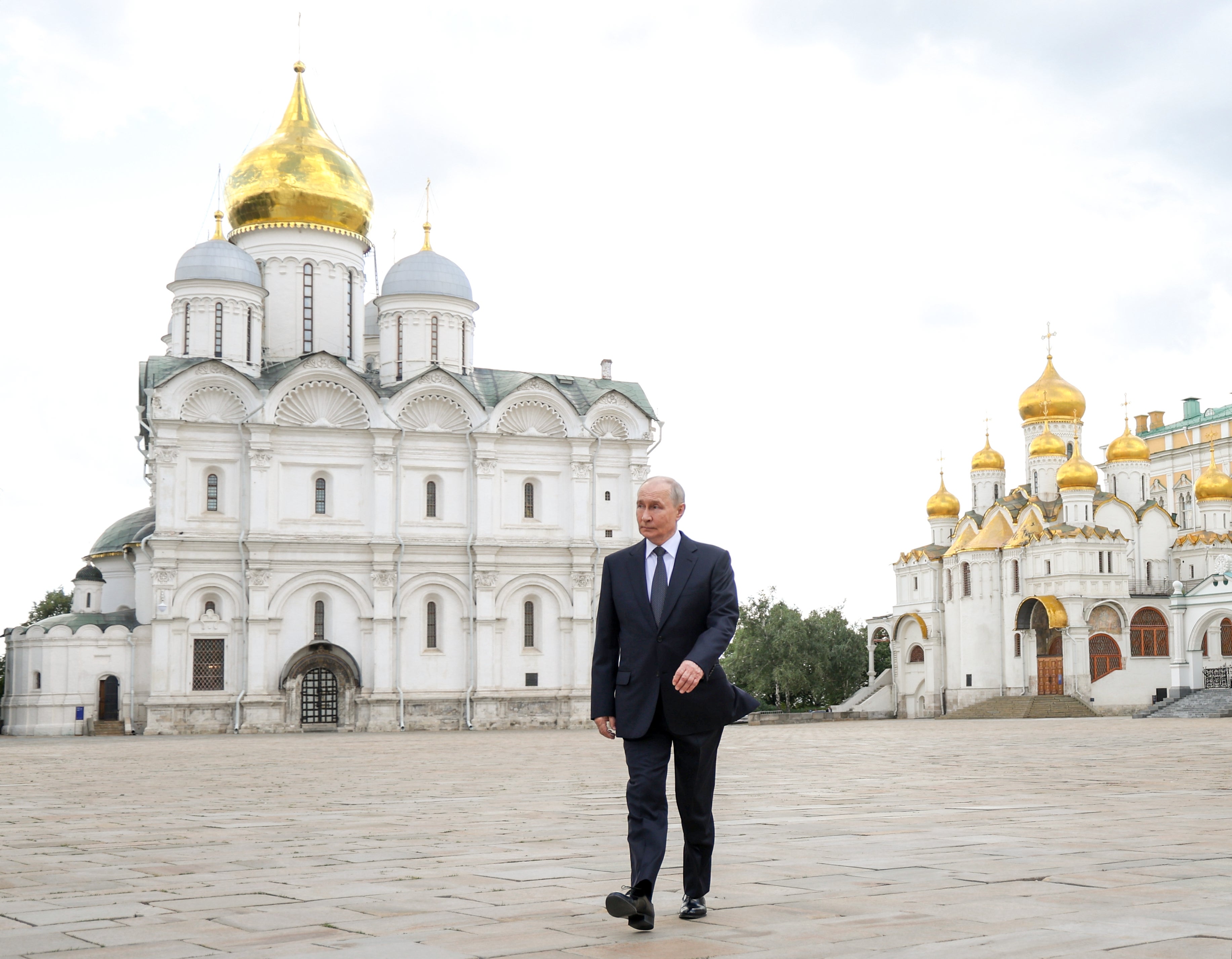 Russian President Vladimir Putin walks after attending a prayer service at the relics of the Holy Grand Prince Dmitry Donskoy, which were discovered during restoration works at the Archangel Cathedral of the Kremlin, left, in Mosсow, on Thursday, Aug. 20, 2026. (Vyacheslav Prokofiev, Sputnik, Kremlin Pool Photo via AP)