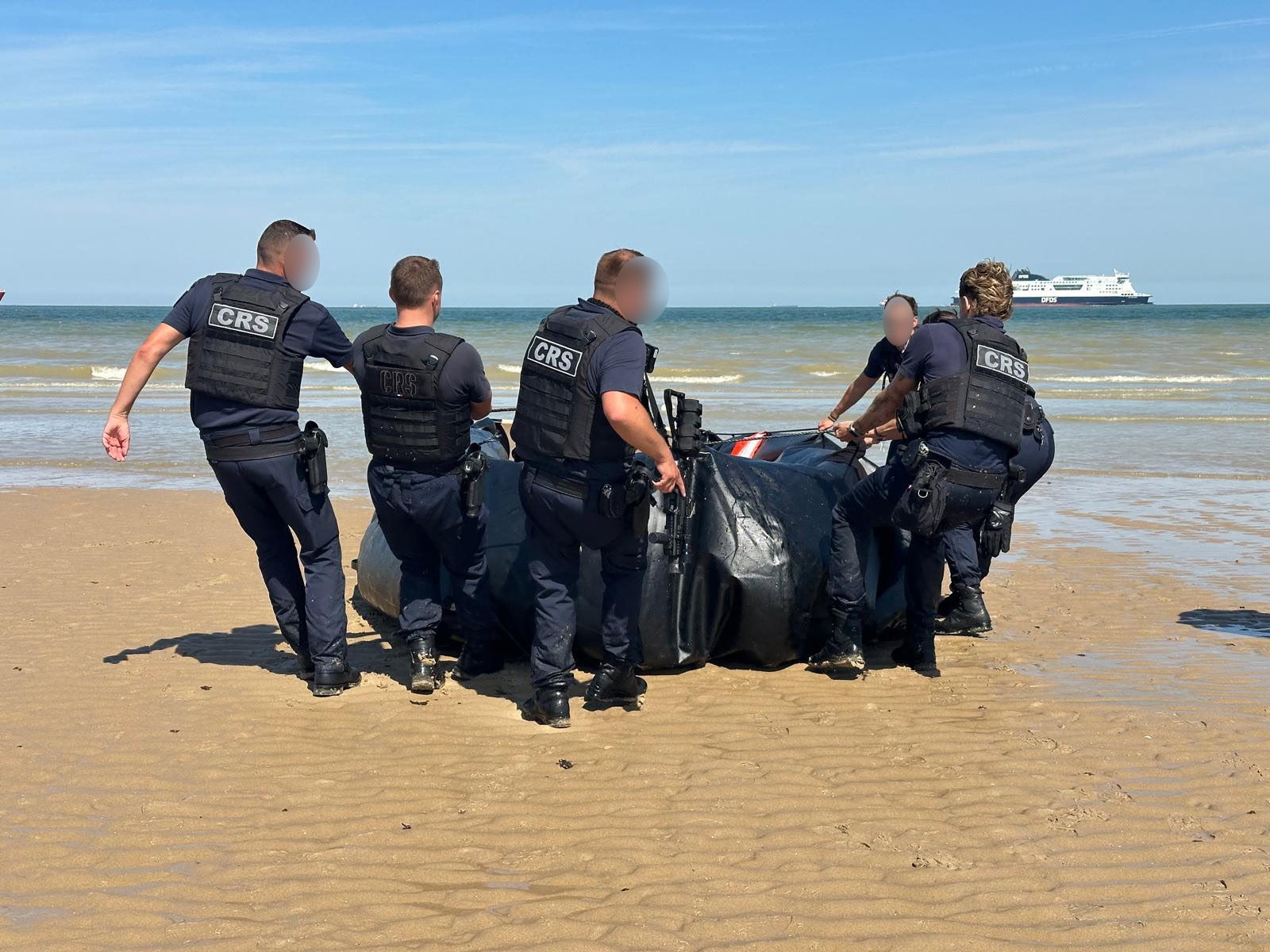 French police officers seizing a small boat