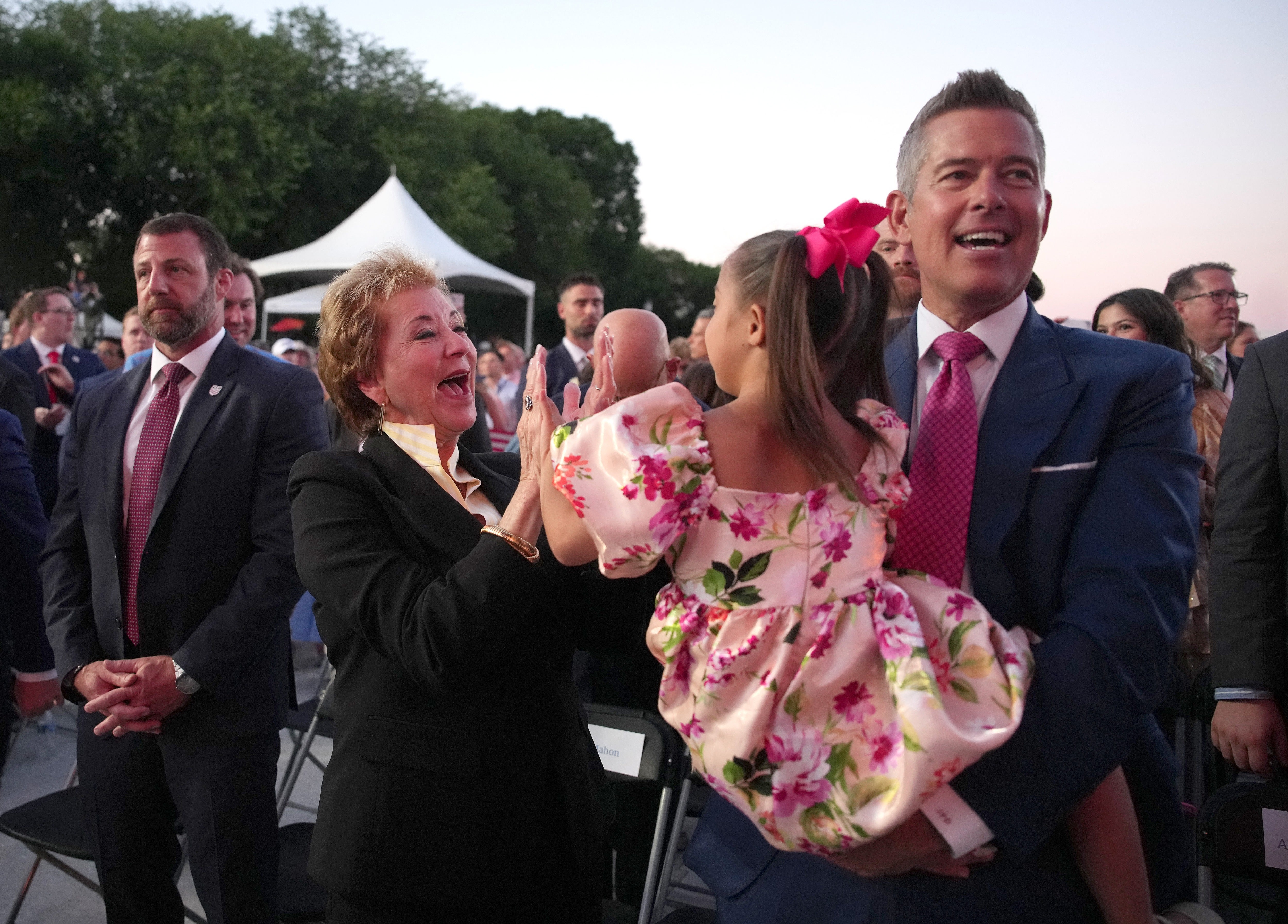The AI image appeared to depict the president alongside Education Secretary Linda McMahon (left) and Transportation Secretary Sean Duffy (right)