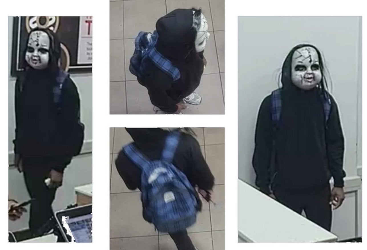 Hughes, believed to be pictured here wearing the Chucky mask, could face charges including terroristic threats, harassment, simple assault, reckless endangerment and intimidation