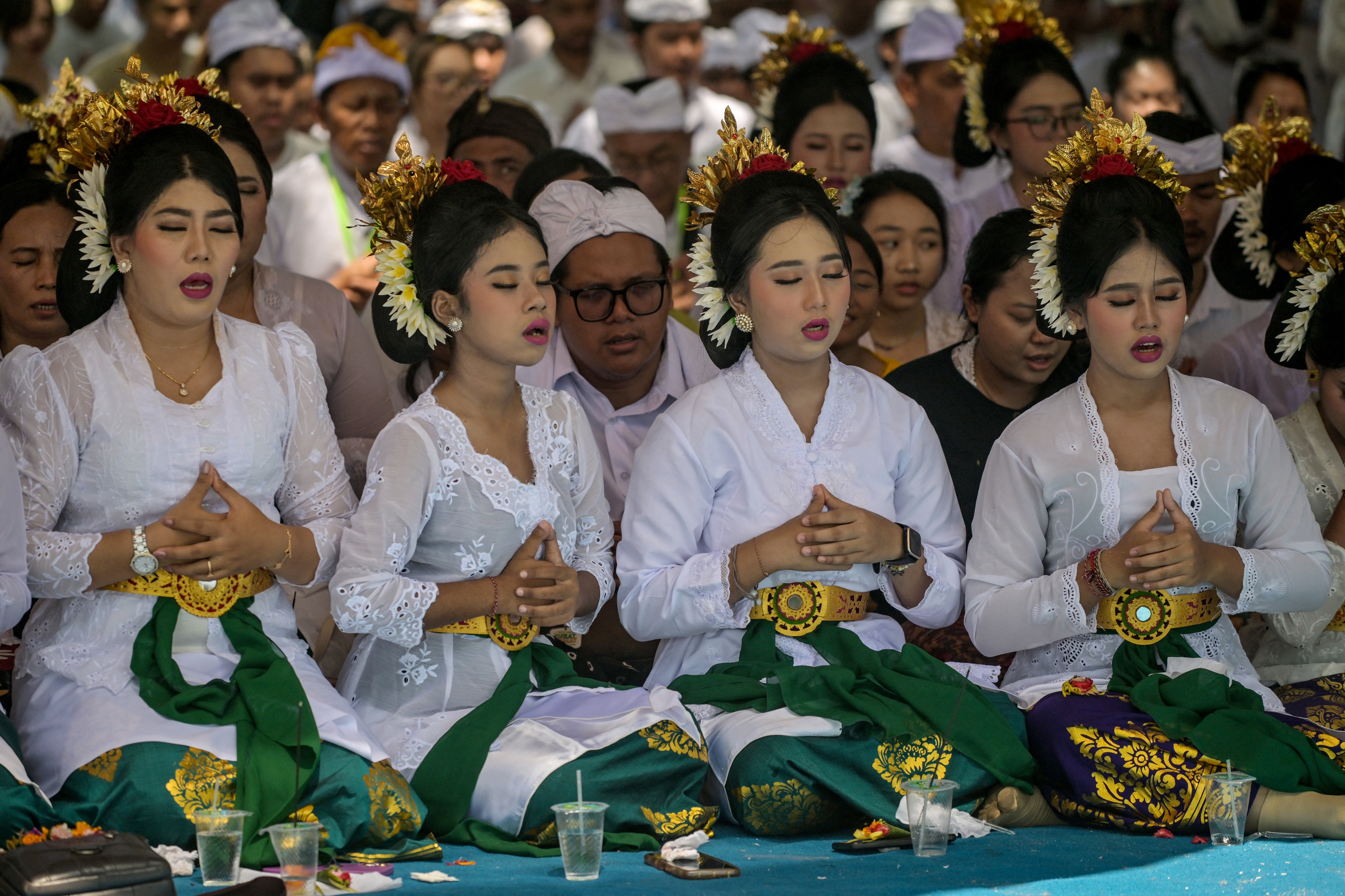 Hindu devotees pray during the Melasti ceremony prayer at Kenjeran beach in Surabaya on March 14, 2026. Melasti is a purification festival which is held several days before 