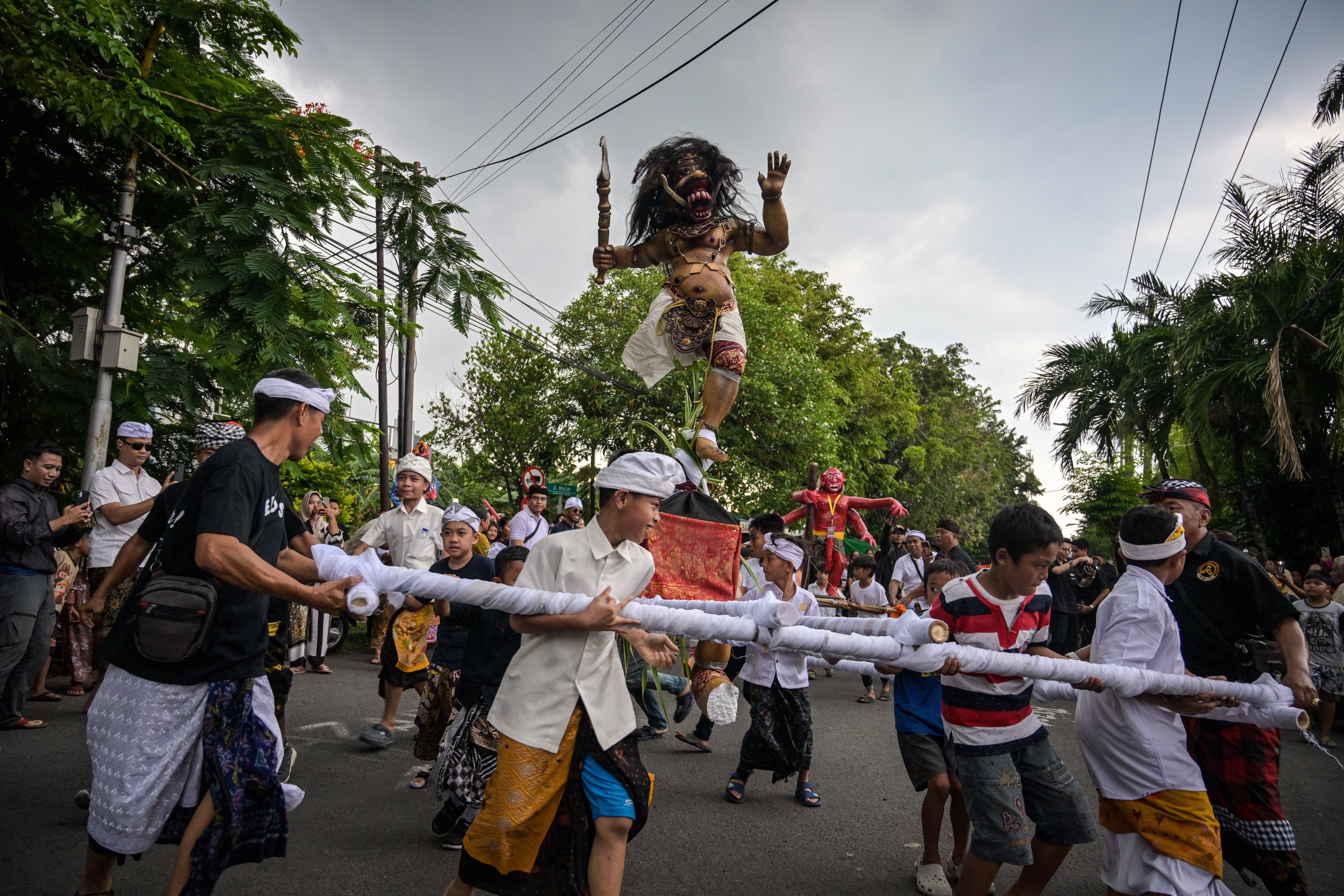 Hindu devotees carry Ogoh-ogoh, a statue symbolising an evil spirit, during a parade on the eve of Nyepi in Surabaya