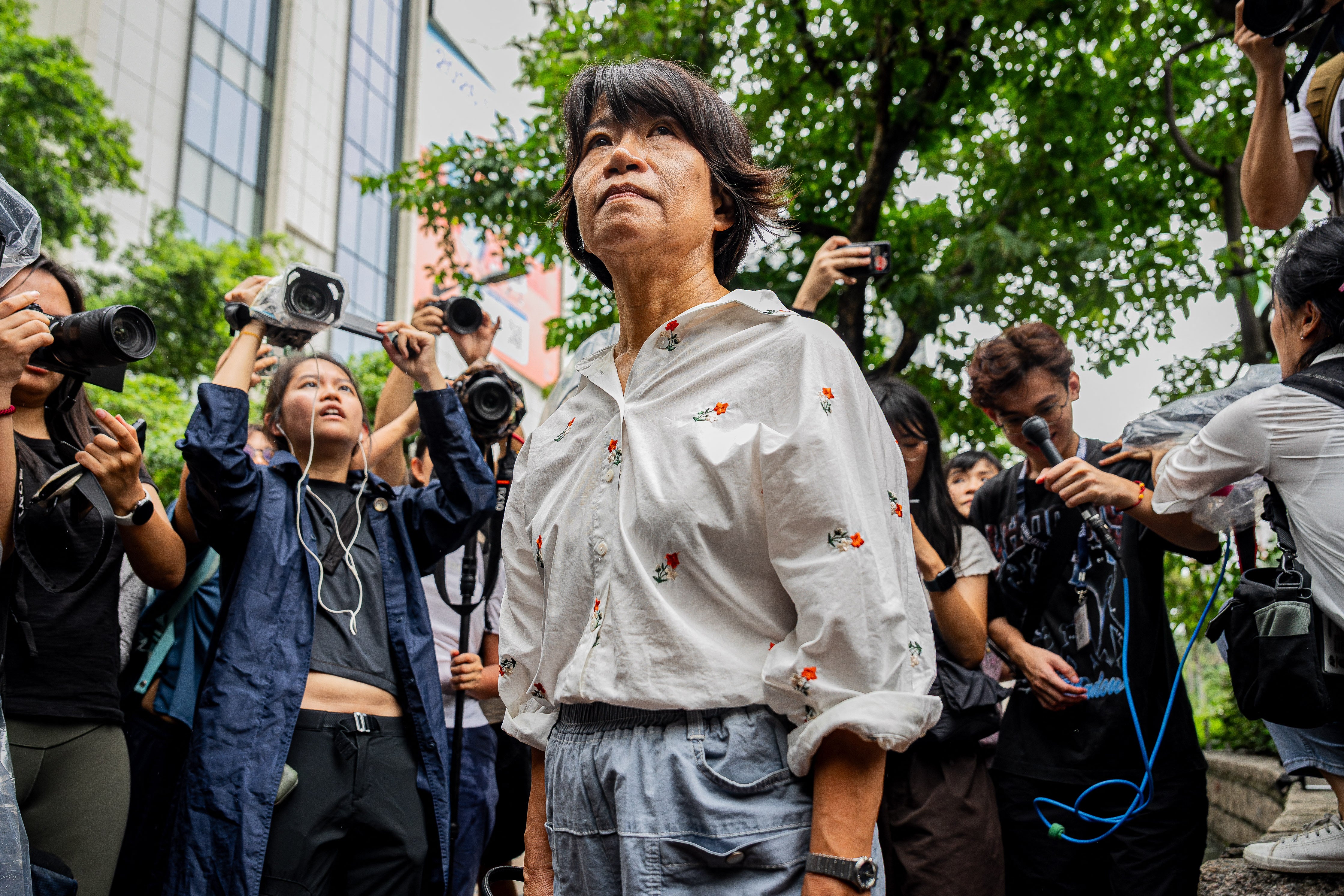 Elizabeth Tang Yin-ngor (C), wife of former union leader Lee Cheuk-yan, leaves the West Kowloon Magistrates' Courts after the verdict in the national security trial of two pro-democracy Tiananmen activists (AFP/Getty)
