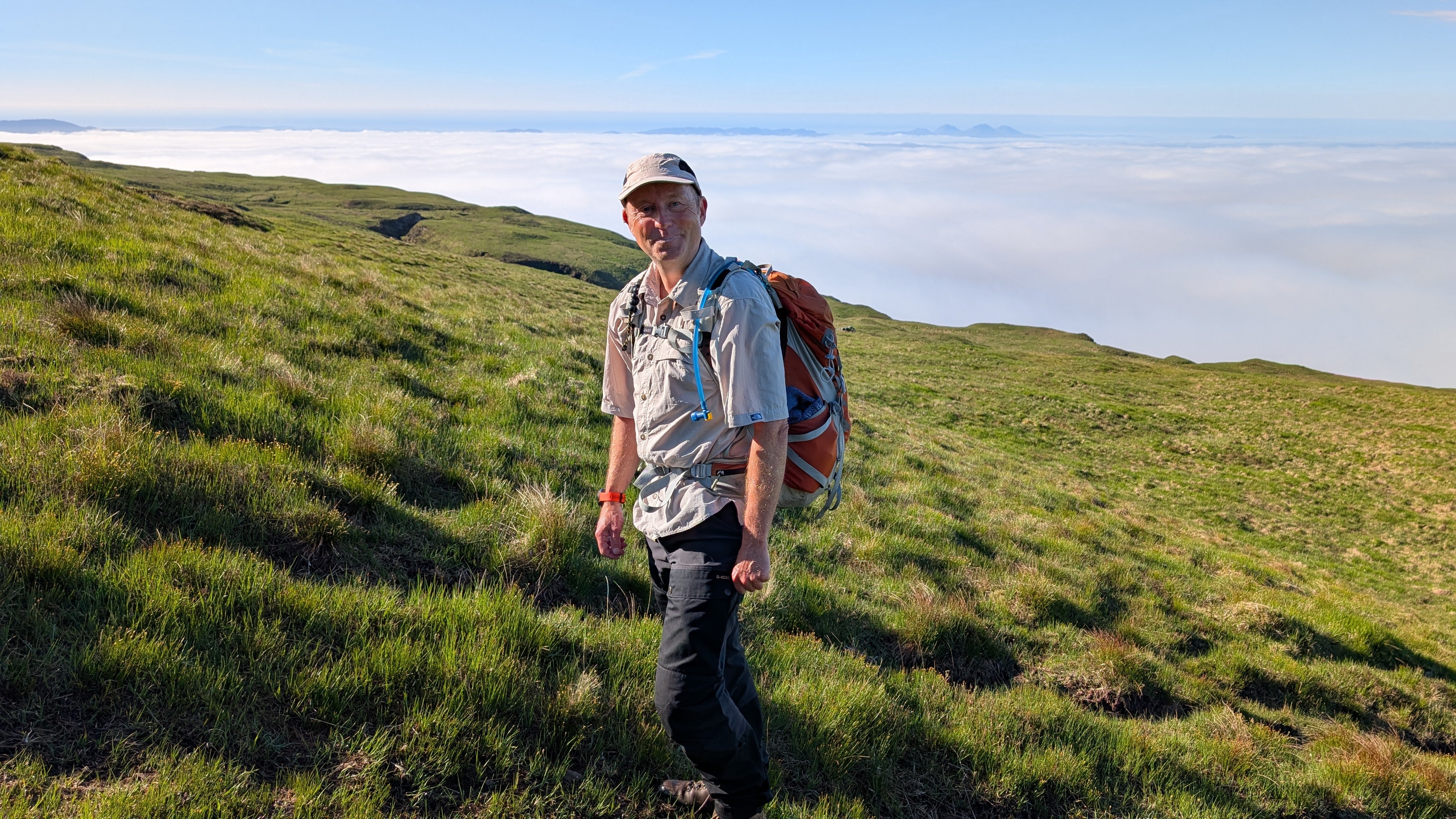 Hiking guide Tony McLean with a cloud inversion in the background and the Paps of Jura poking out