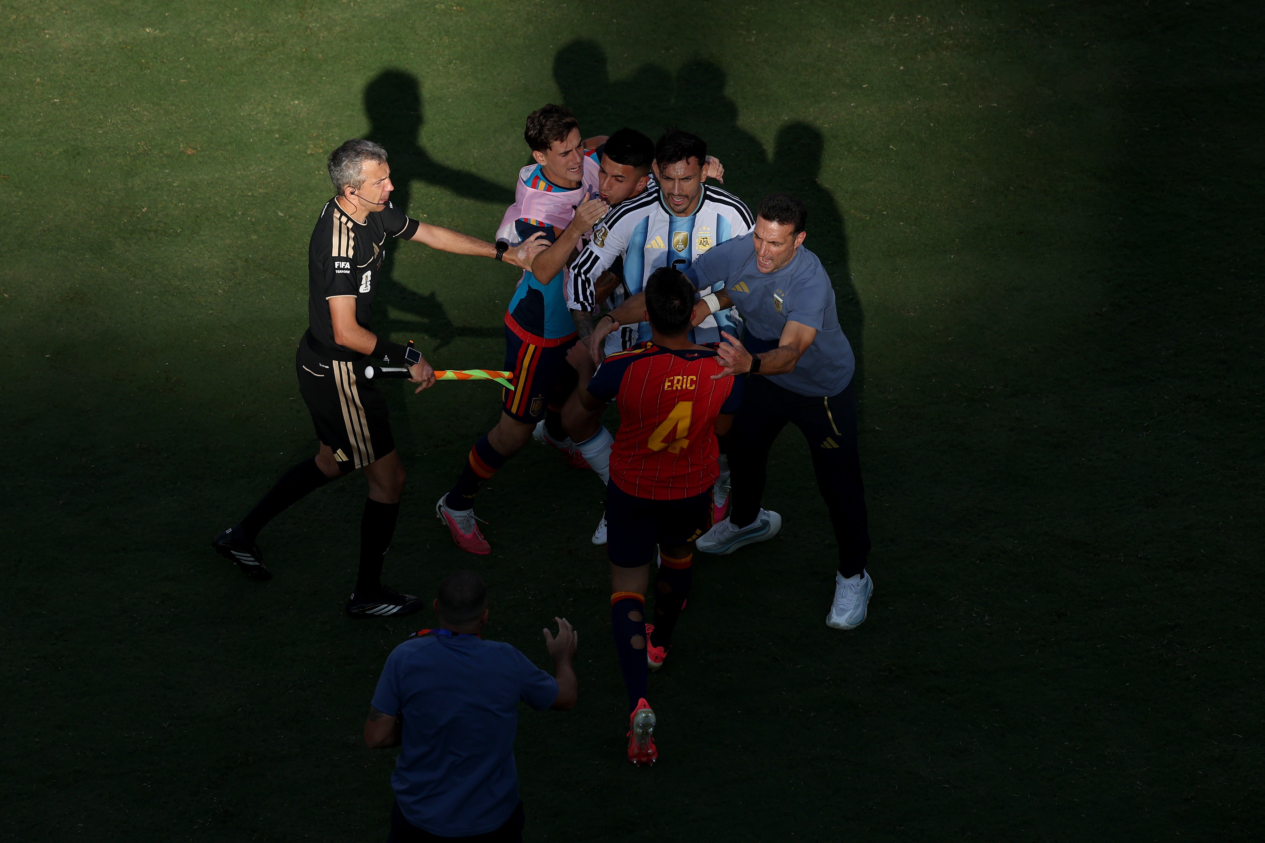 Leandro Paredes #5 of Argentina and Eric Garcia #4 of Spain argue while Lionel Scaloni, Head Coach of Argentina, tries to separate