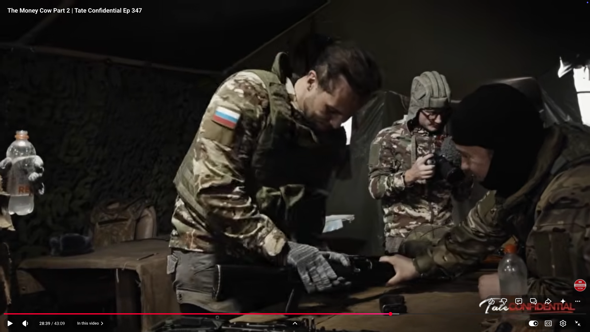 Tristan Tate in camouflage adorned with the Russian flag
