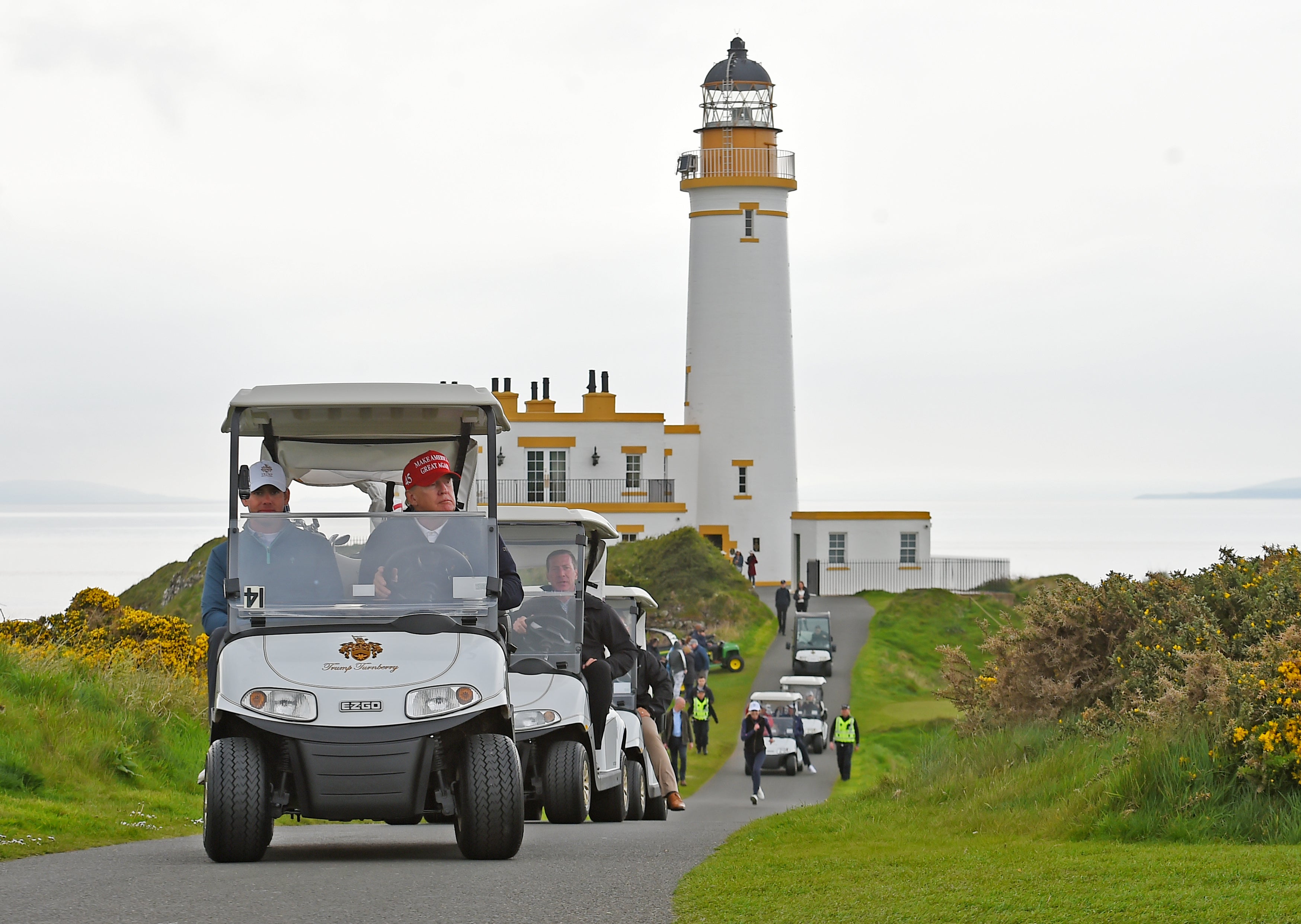 New photos show Natalie Harp sprinting after Trump's golf cart in Scotland; letter apologizes for being 'an embarrassment walking the course'