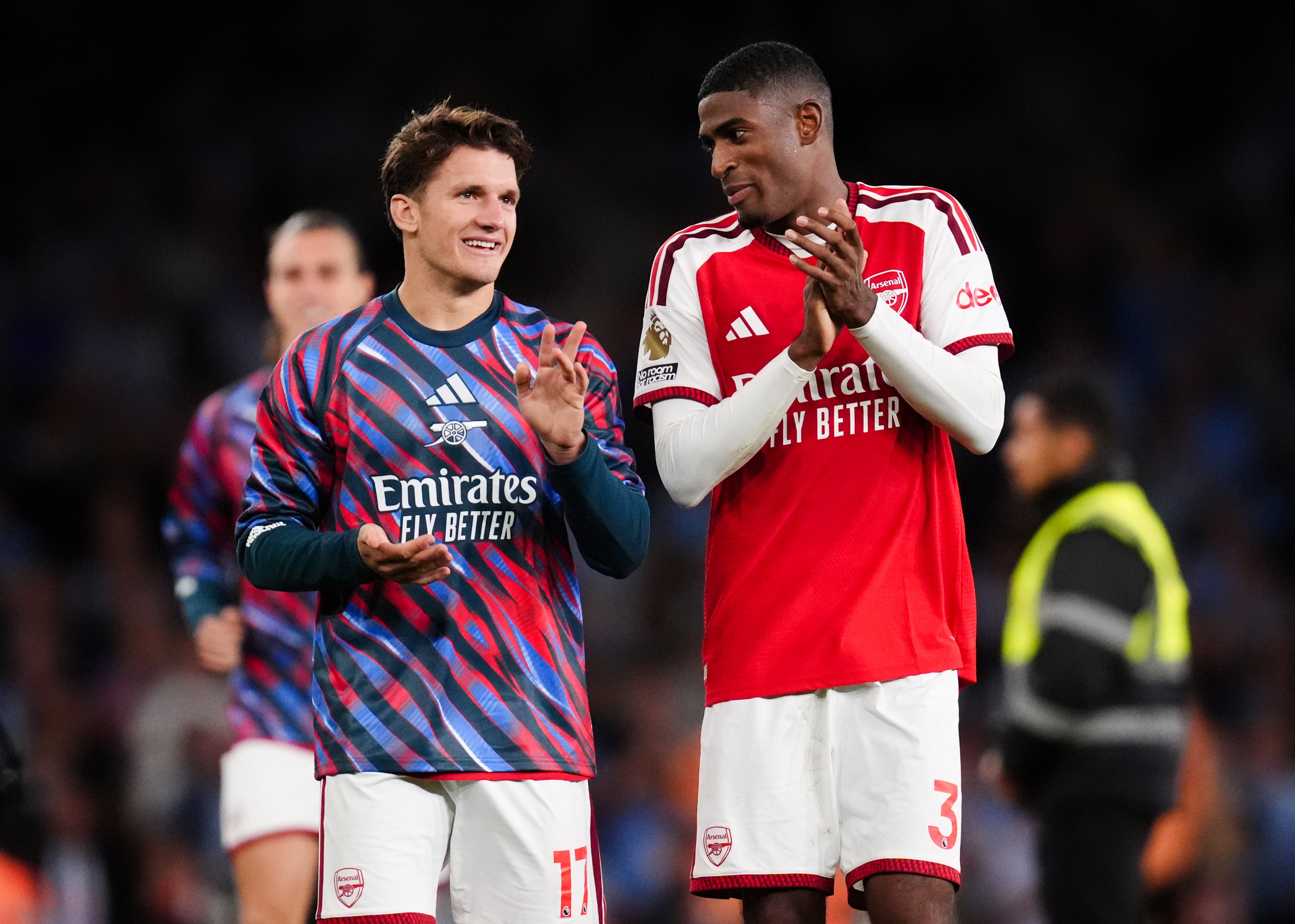 Christos Tzolis and Cristhian Mosquera applaud the Arsenal fans