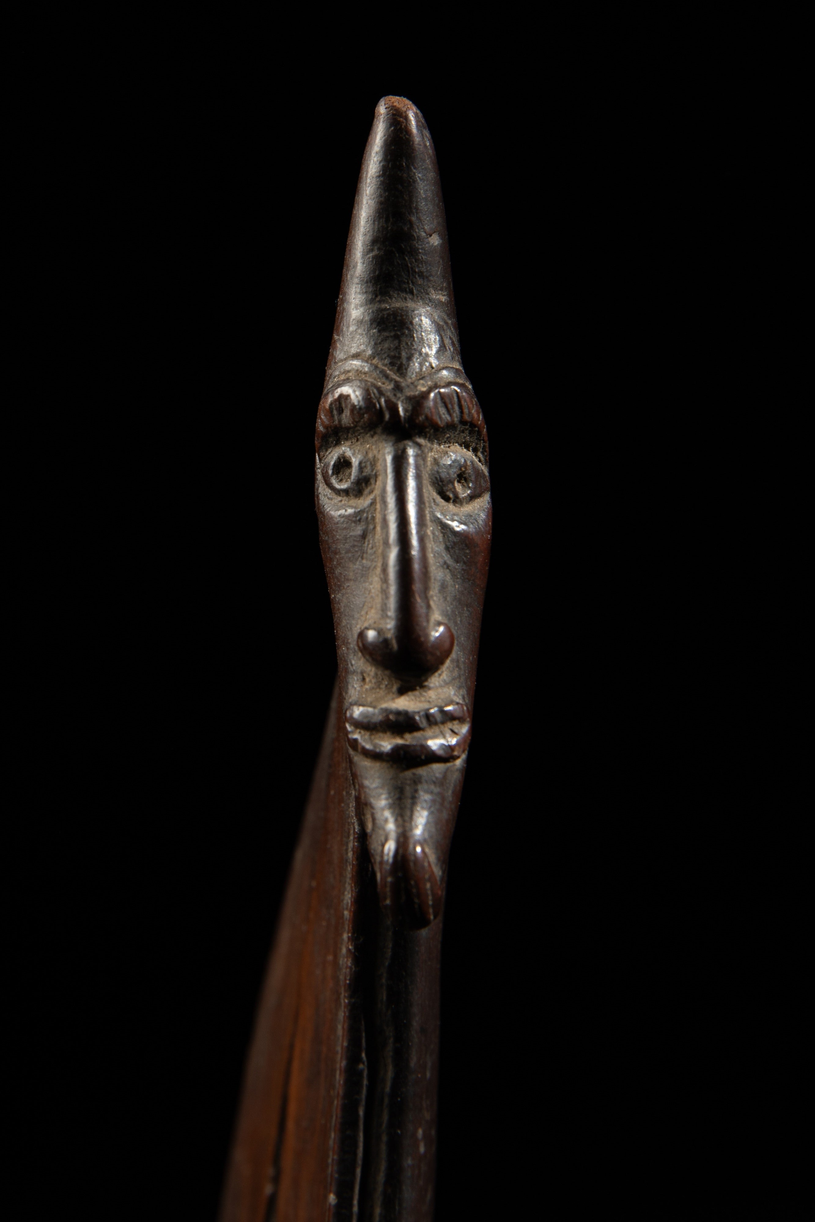 One of the heads on the wooden pendant