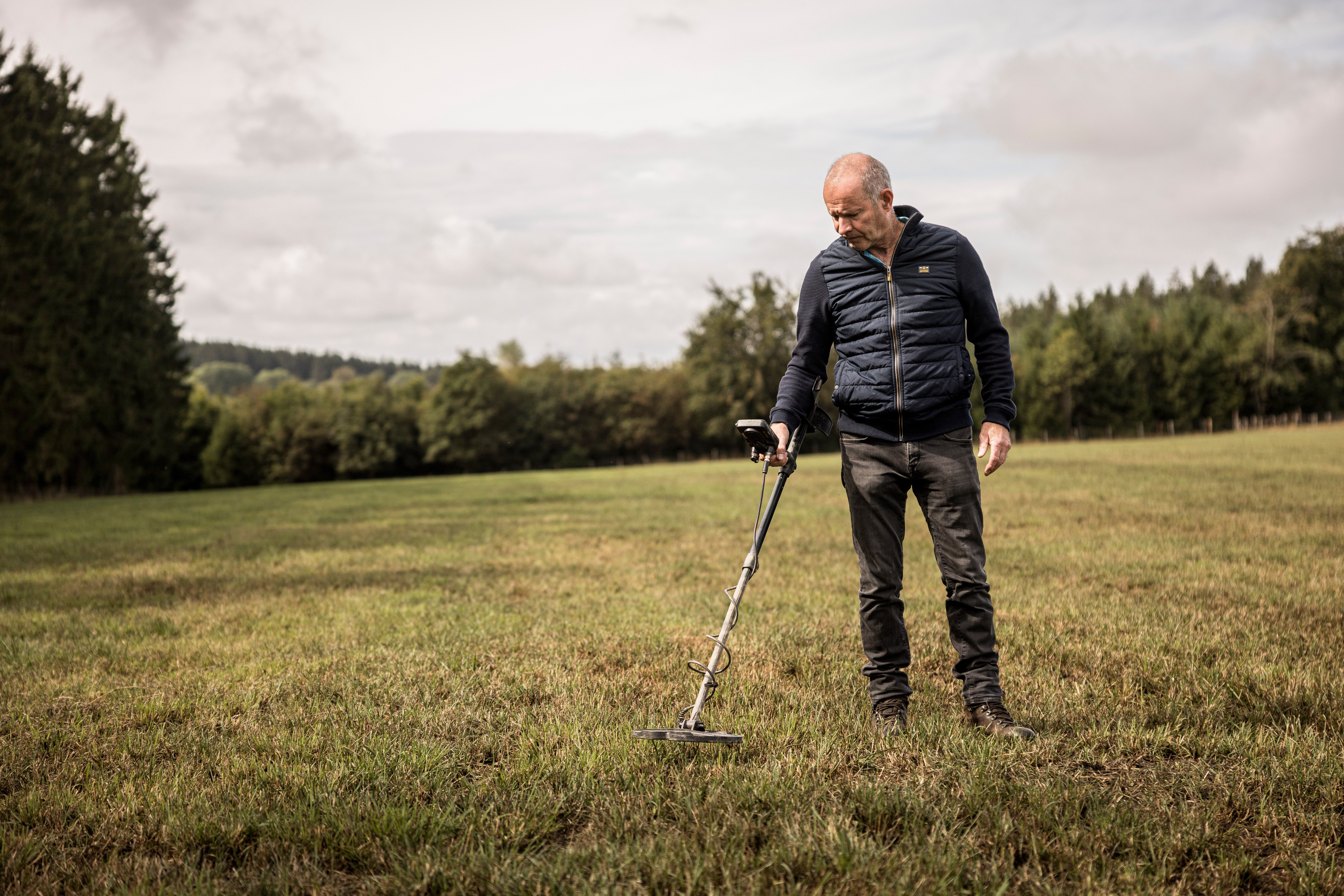 Bernard Collard runs a metal detector over a field in the Elsenborn area of Krinkelt, Belgium
