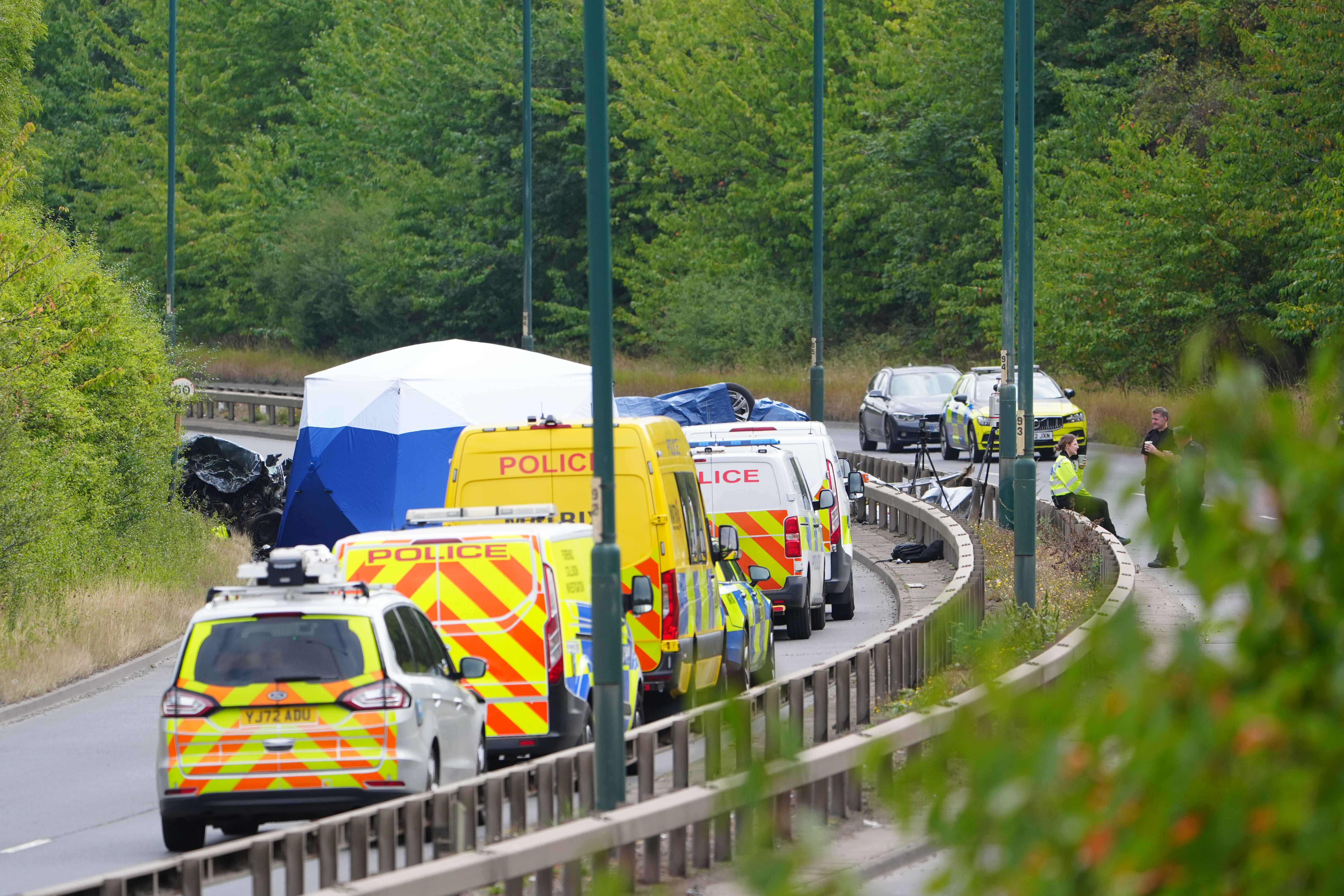 Police officers at the scene of a fatal crash involving a police car and a Volkswagen Passat on the A66 in South Bank, near Middlesbrough