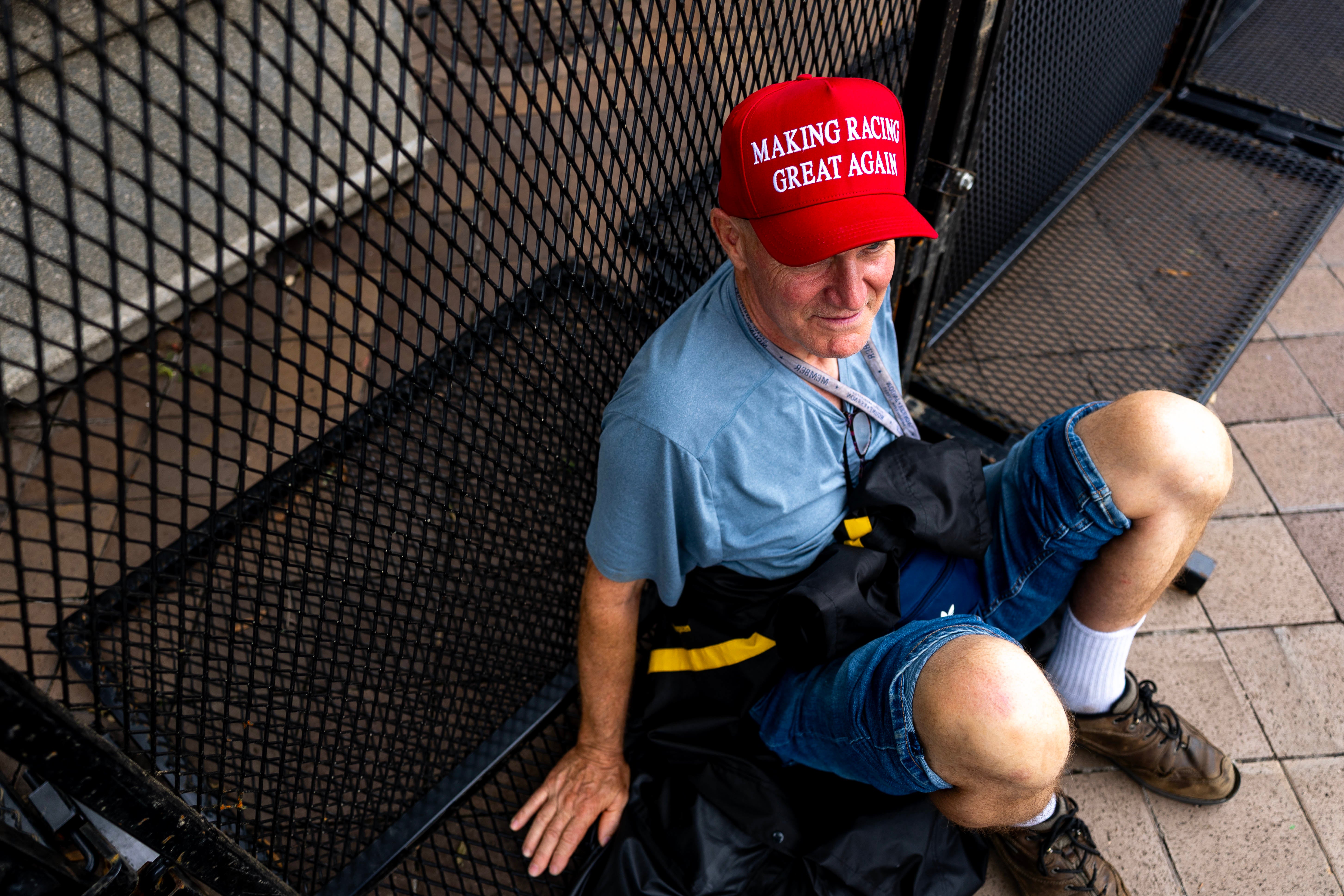 A spectator takes a break while watching the practice rounds of the Freedom 250 Grand Prix Saturday afternoon