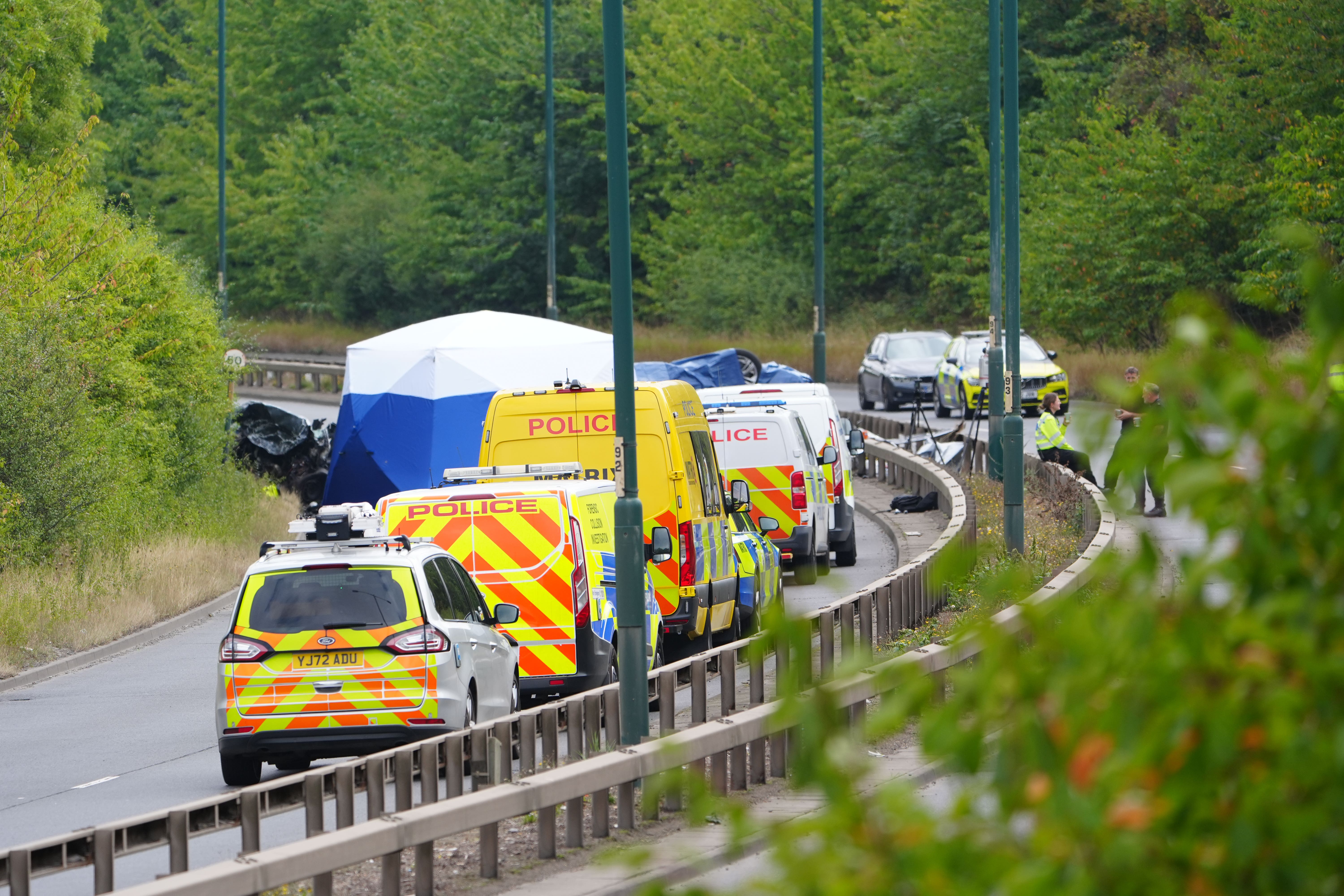Police officers at the scene of the fatal crash involving a police car and a Volkswagen Passat on the A66